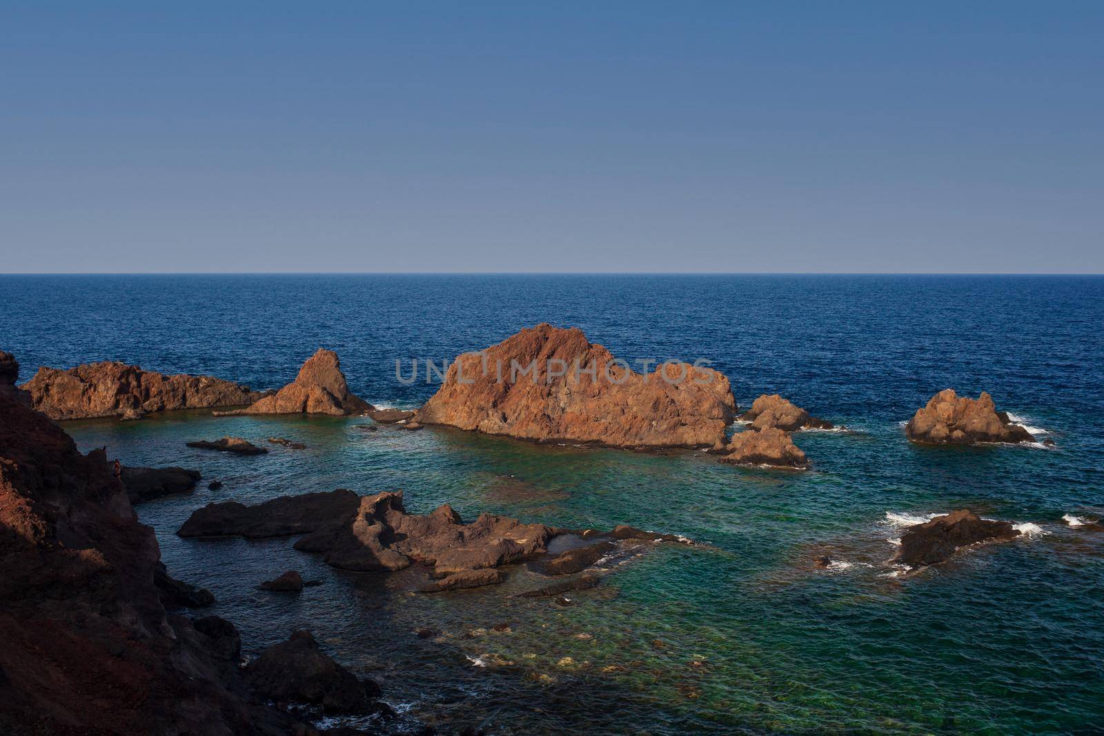 View of the lava beach of Linosa Called Faraglioni, Sicily. Italy