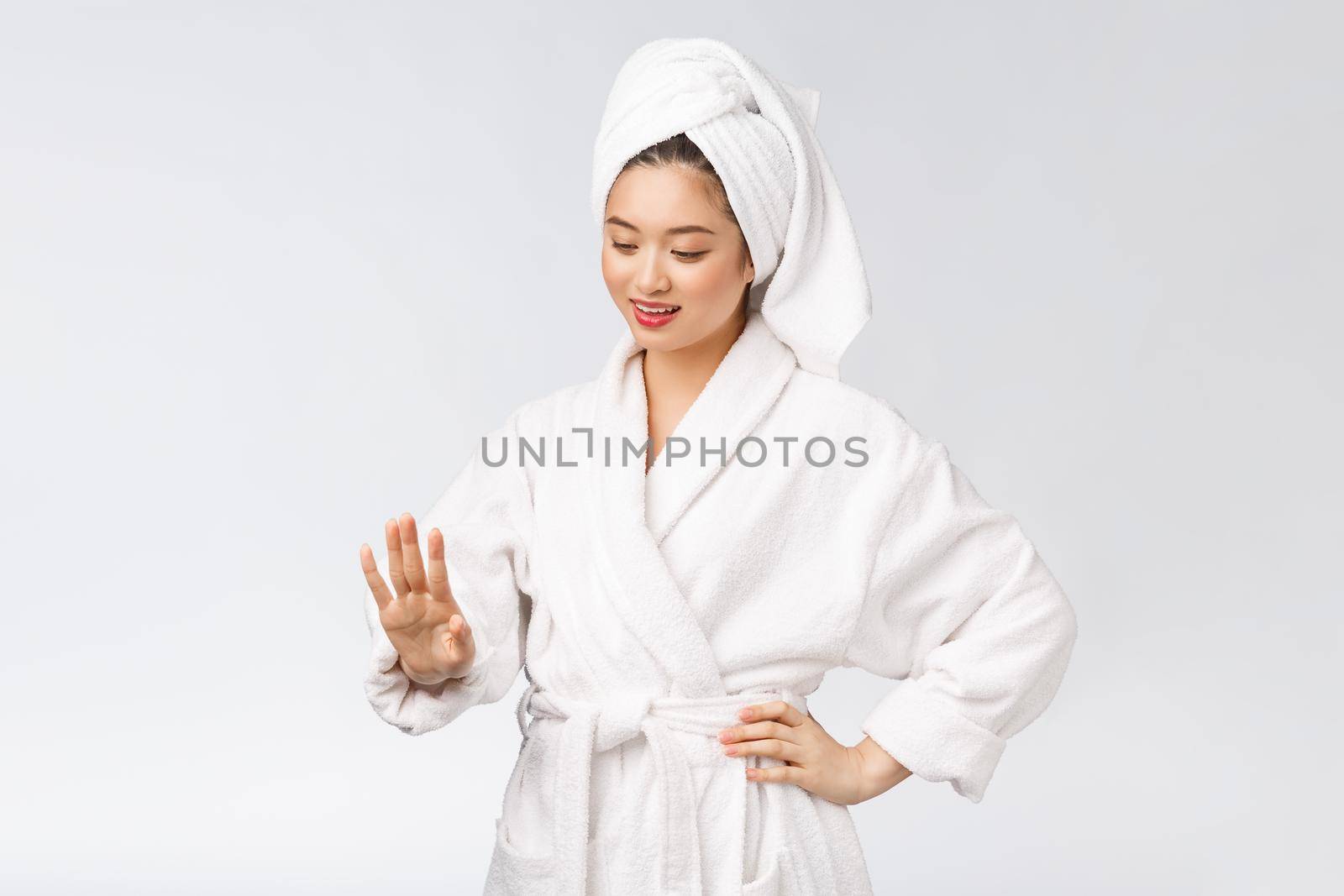 beauty asian girl who checks her skin. skin care. Isolated over white background