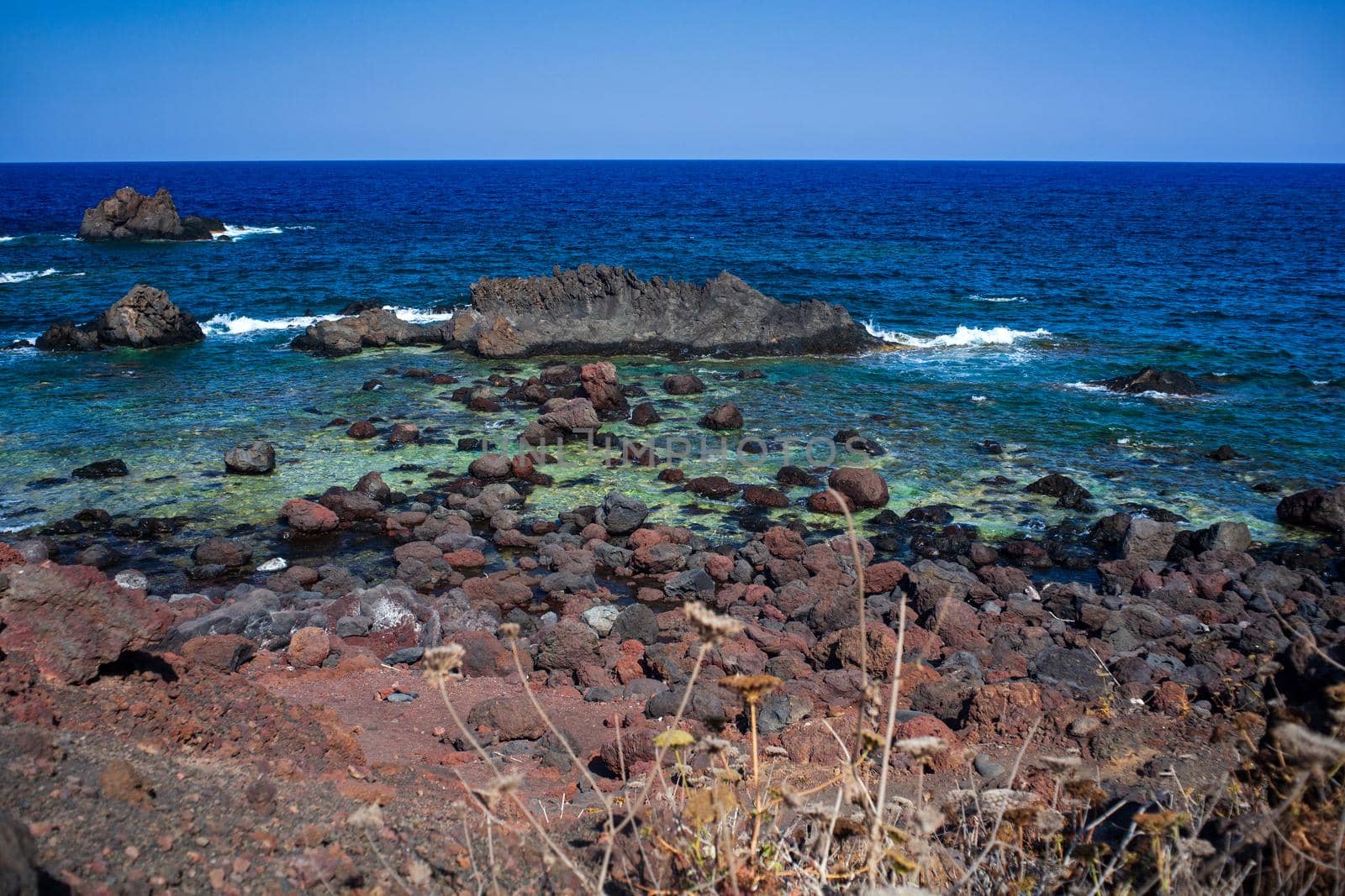 View of the lava beach of Linosa Called Faraglioni, Sicily. Italy