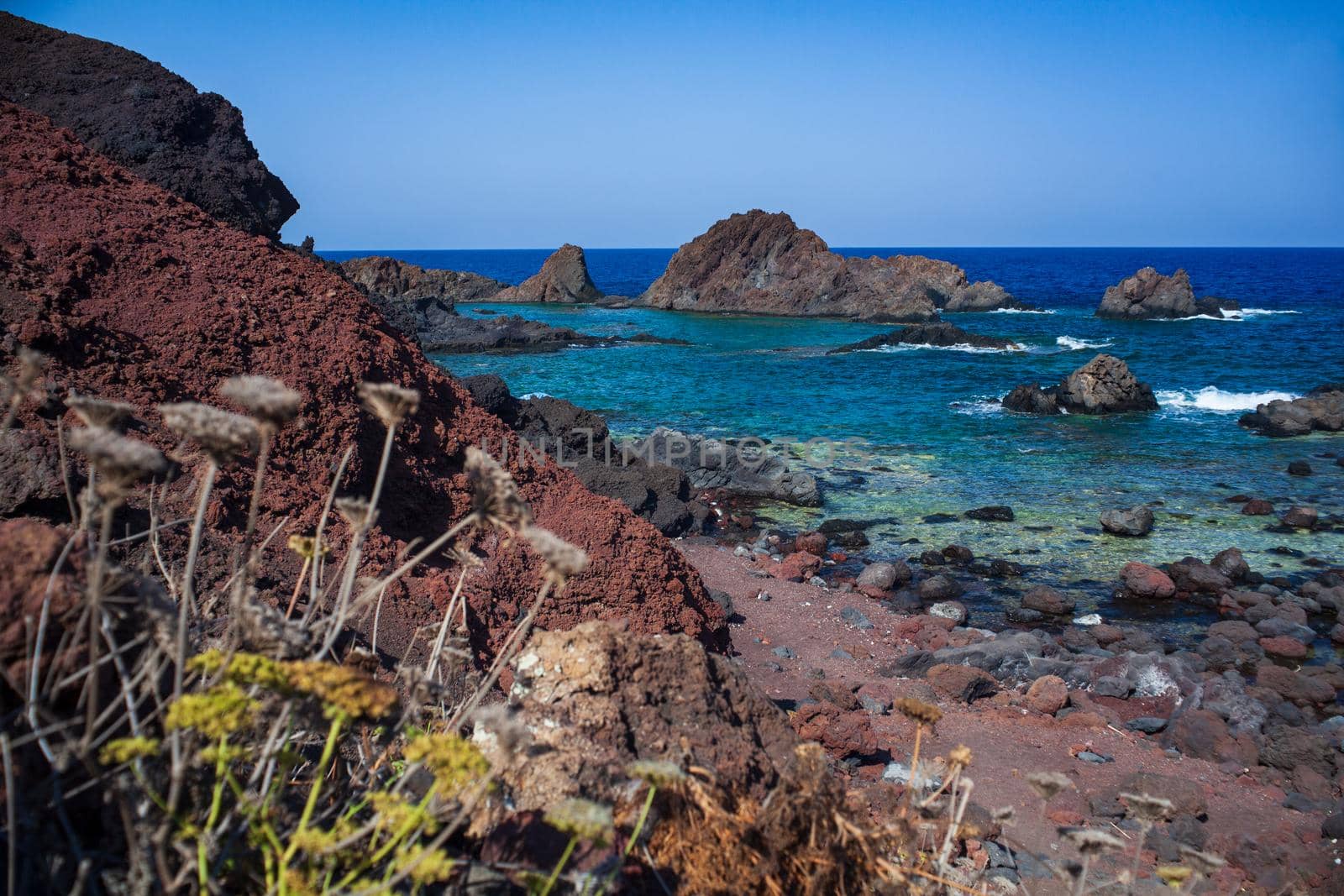View of the lava beach of Linosa Called Faraglioni by bepsimage