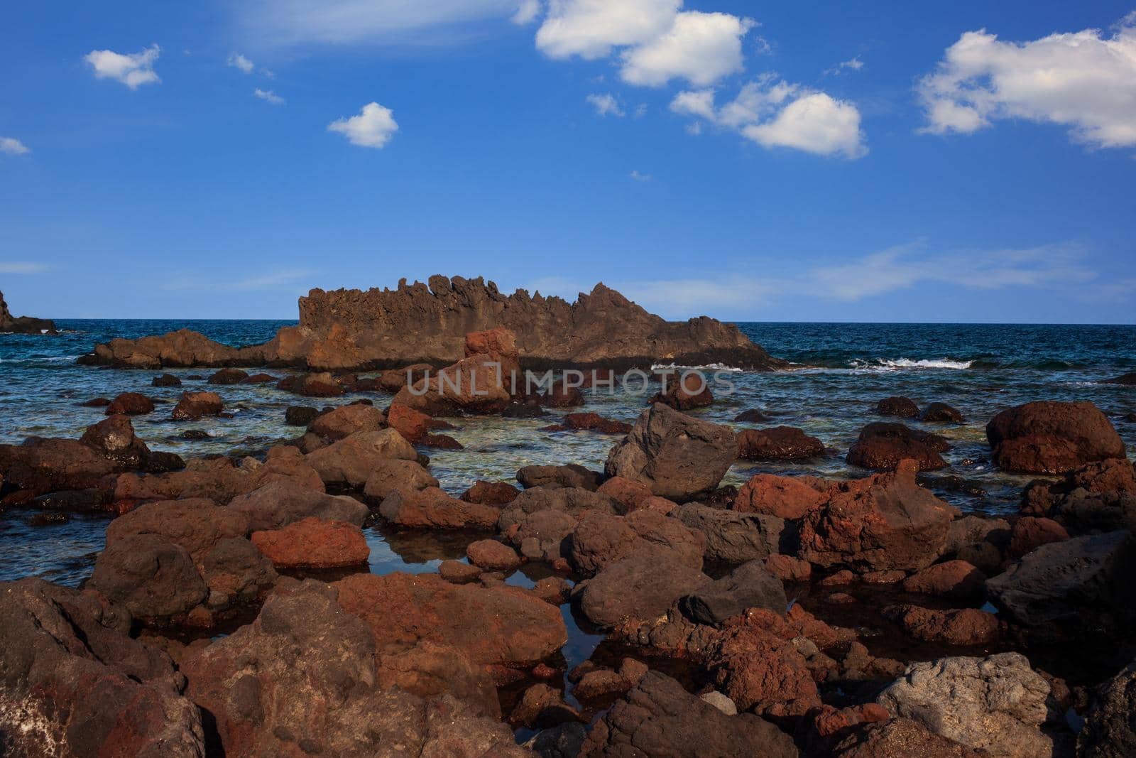 View of the lava beach of Linosa Called Faraglioni, Sicily. Italy