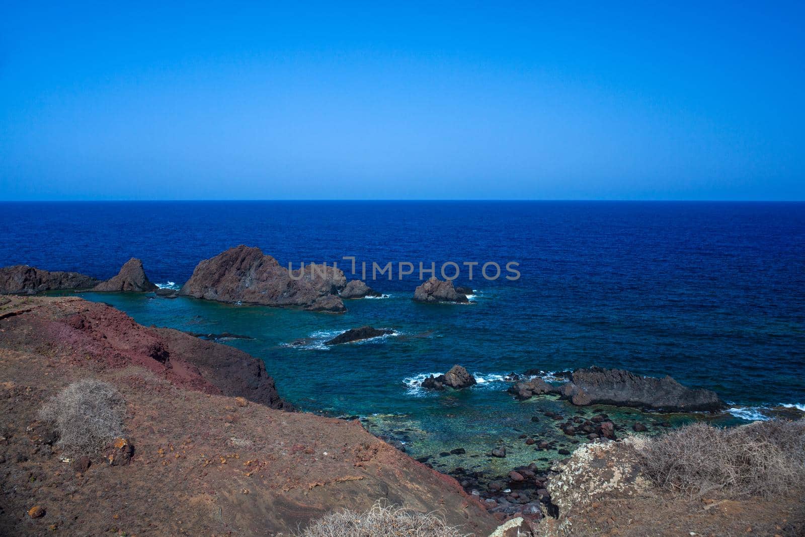 View of the lava beach of Linosa Called Faraglioni by bepsimage