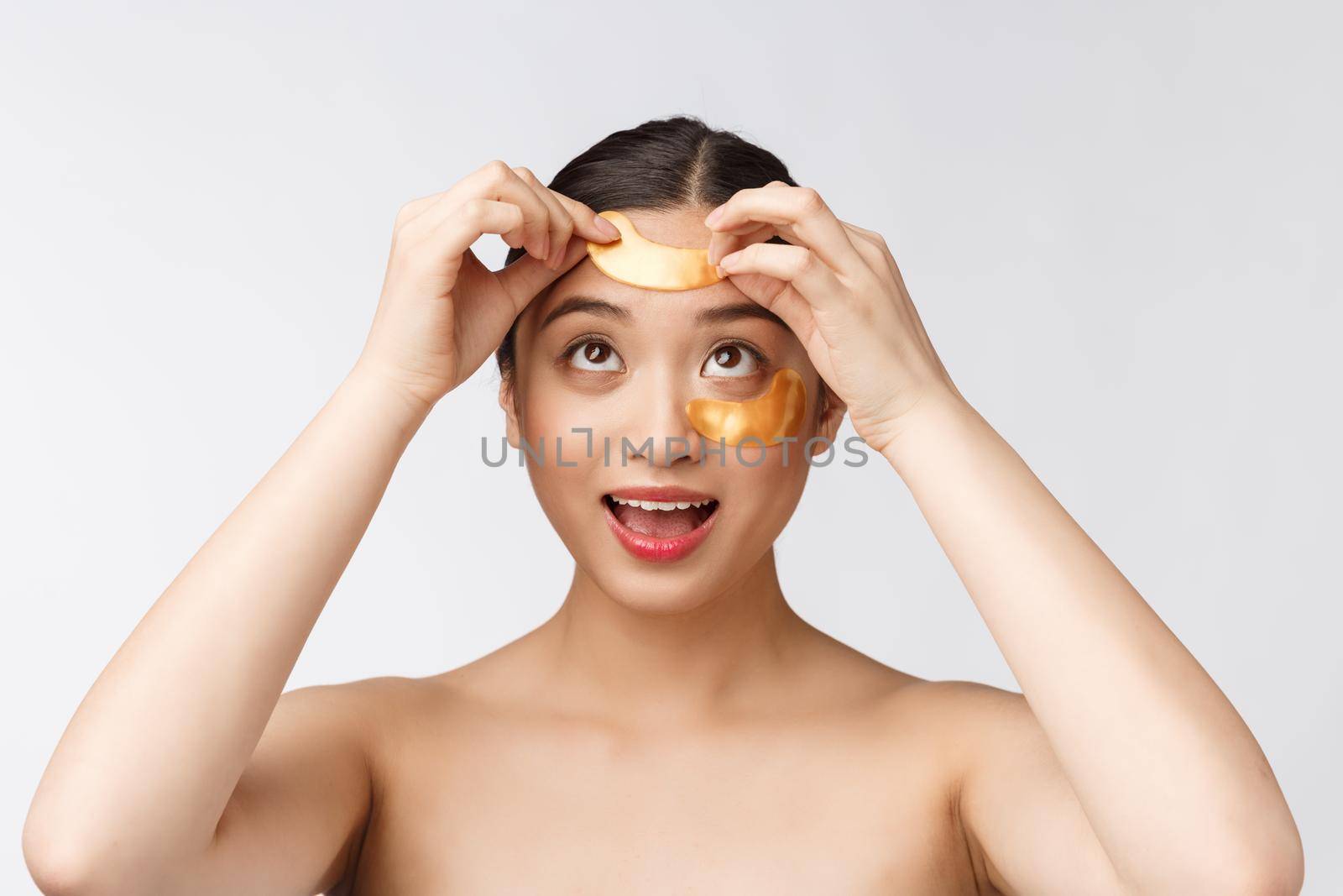 Asian beauty teenager woman care her skin with gold eye masks patches under eyes.