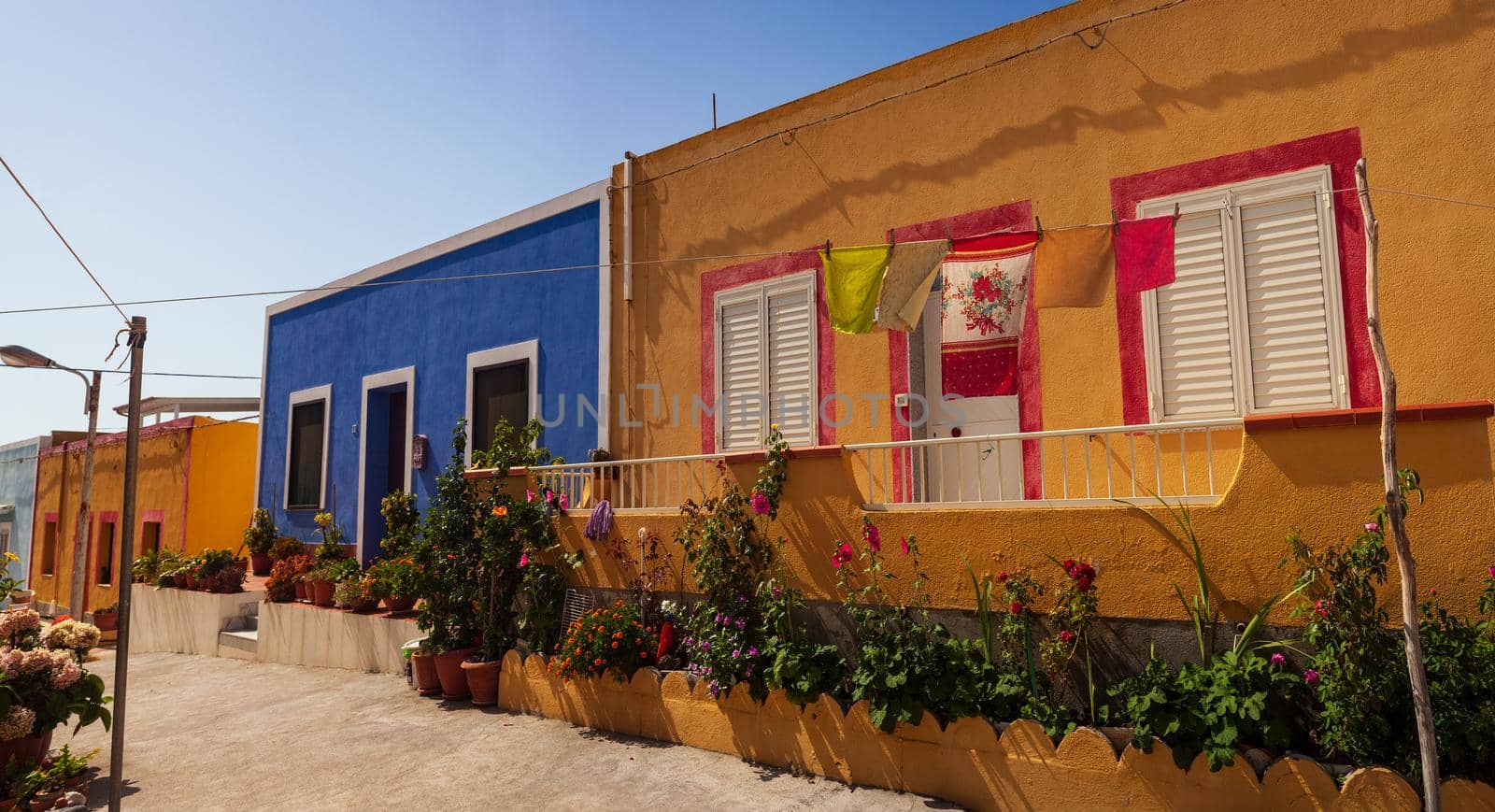 View of a typical colorful houses of Linosa, colored with blue red and orange, Sicily. Italy