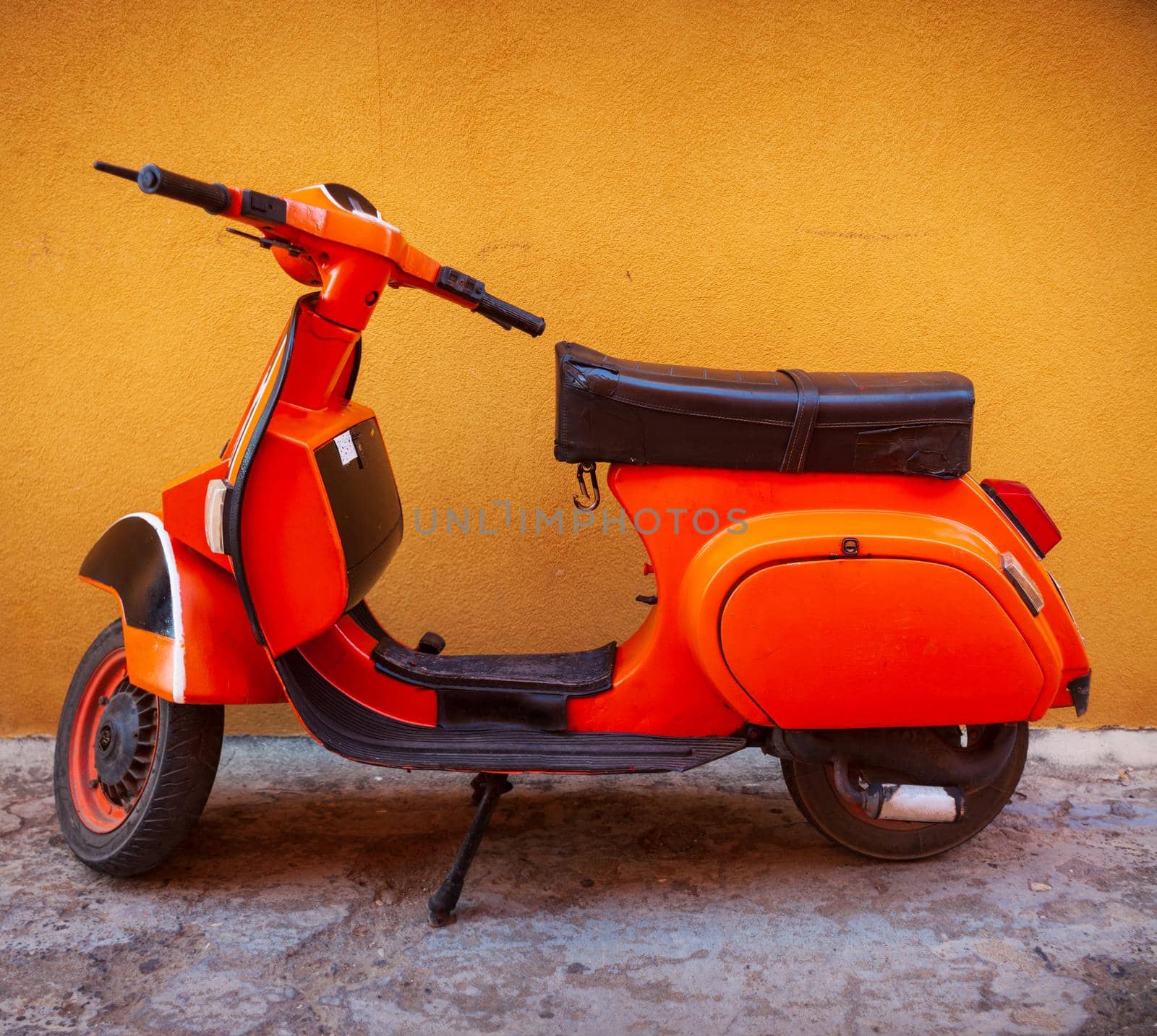 Vespa, famous italian motorcycle parked in the street by bepsimage