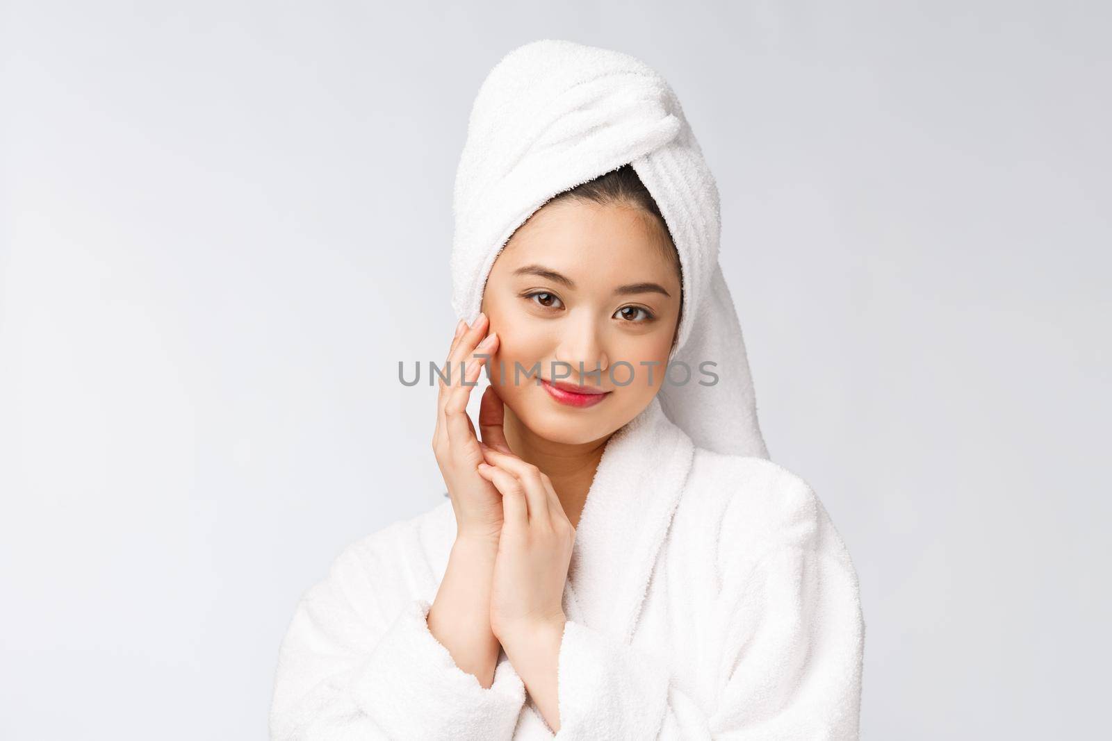 Spa skincare beauty Asian woman drying hair with towel on head after shower treatment. Beautiful multiracial young girl touching soft skin. by Benzoix