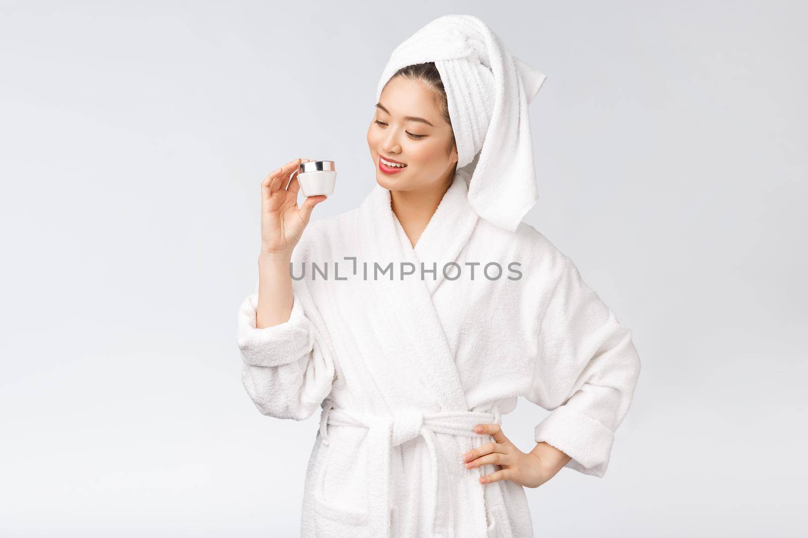 Beauty concept. Asian pretty woman with perfect skin holding cosmetic bottle