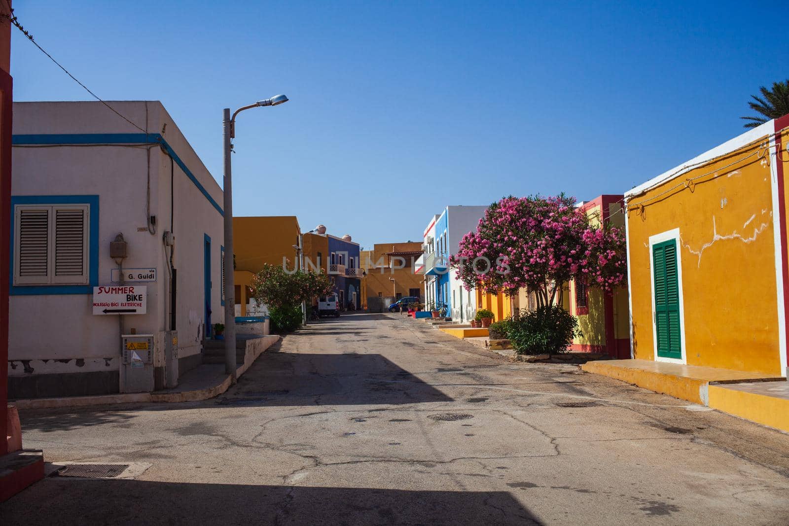 View of a typical street of Linosa with colorful house by bepsimage