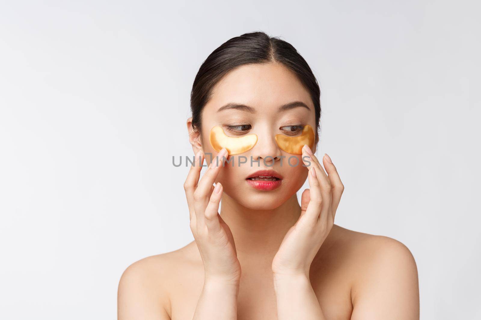 Asian beauty teenager woman care her skin with gold eye masks patches under eyes by Benzoix