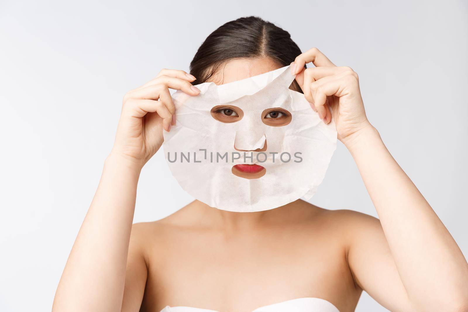 Spa, healthcare. Woman with purifying mask on her face isolated on white background. by Benzoix