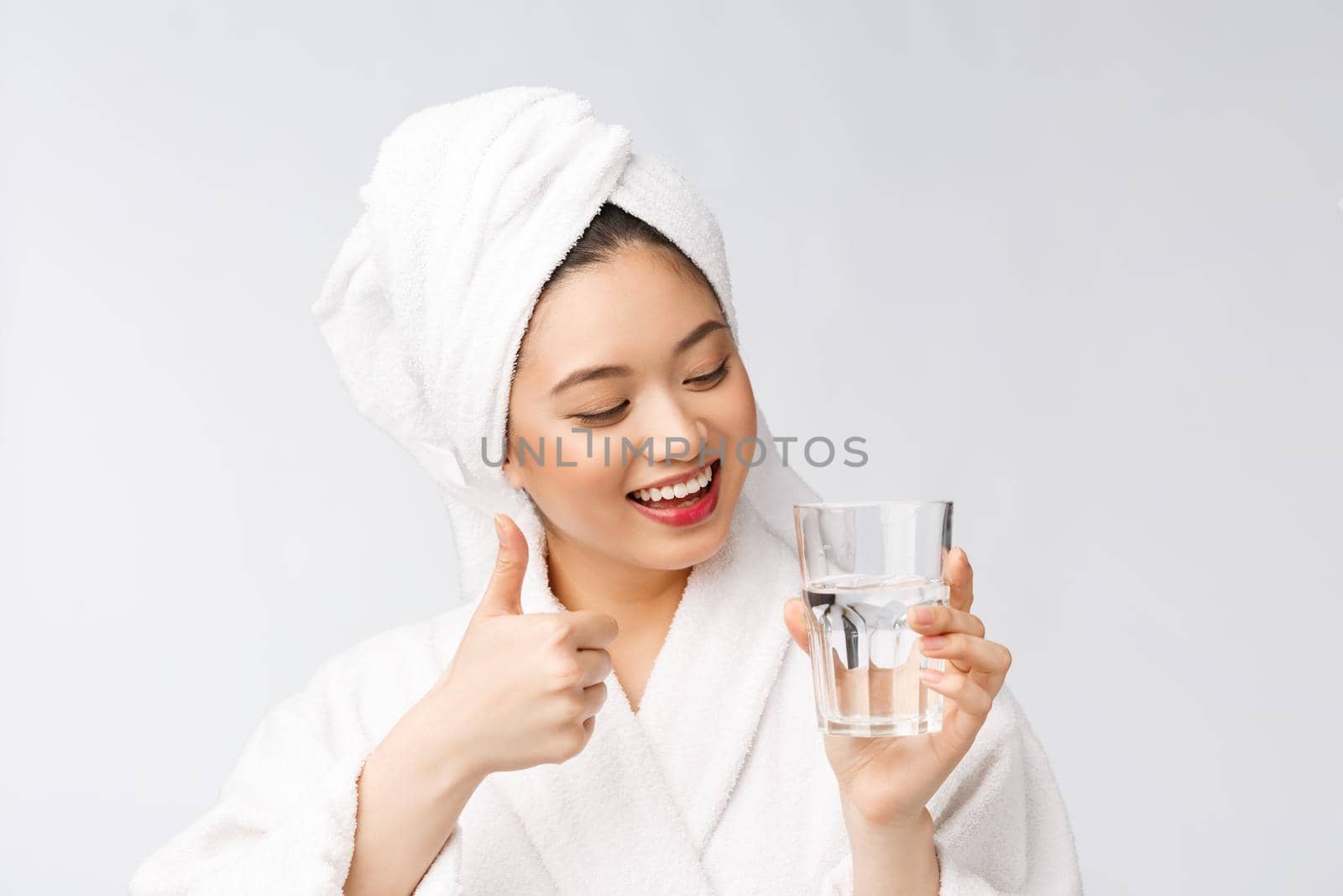 Healthy young beautiful woman drinking water, beauty face natural makeup, isolated over white background
