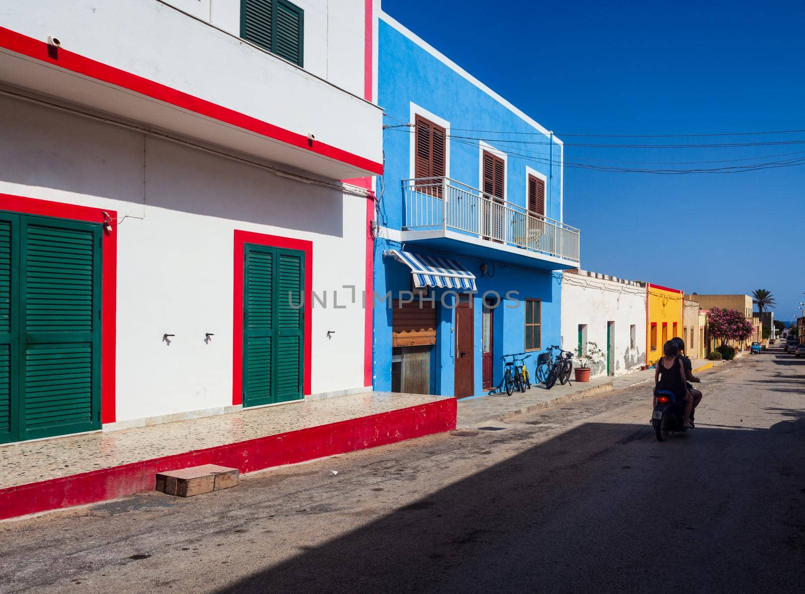 View of a typical colorful houses of Linosa, colored with white red and cyan, Sicily. Italy