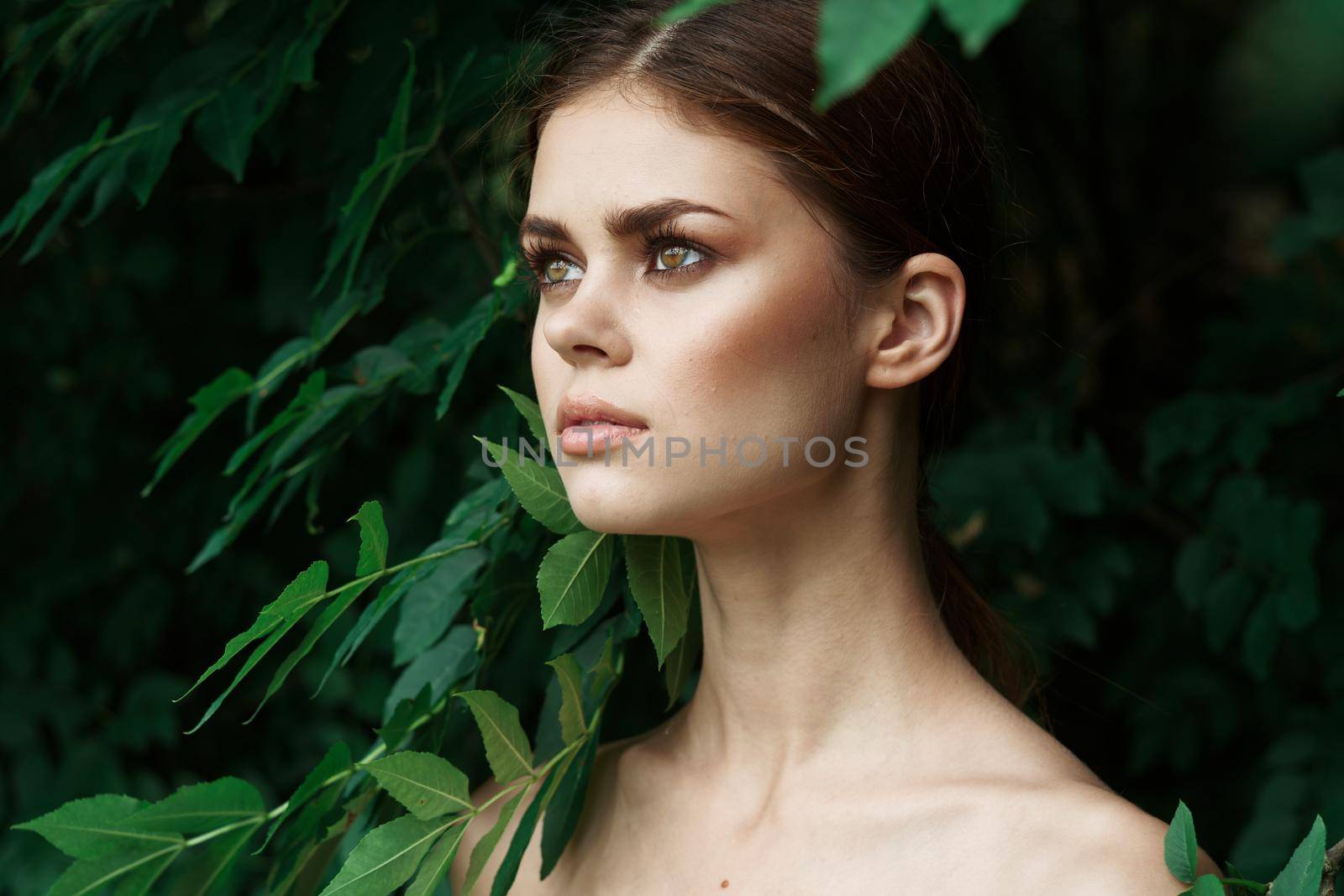 attractive woman green leaves clean skin nature summer close-up by Vichizh