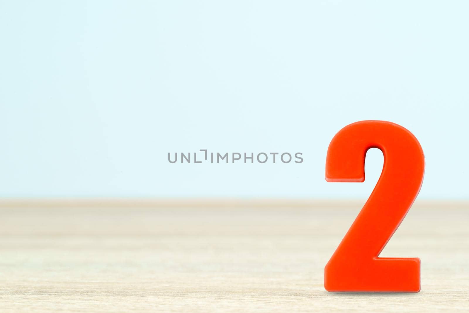 Shot of a number two made of red plastic on table with copy space