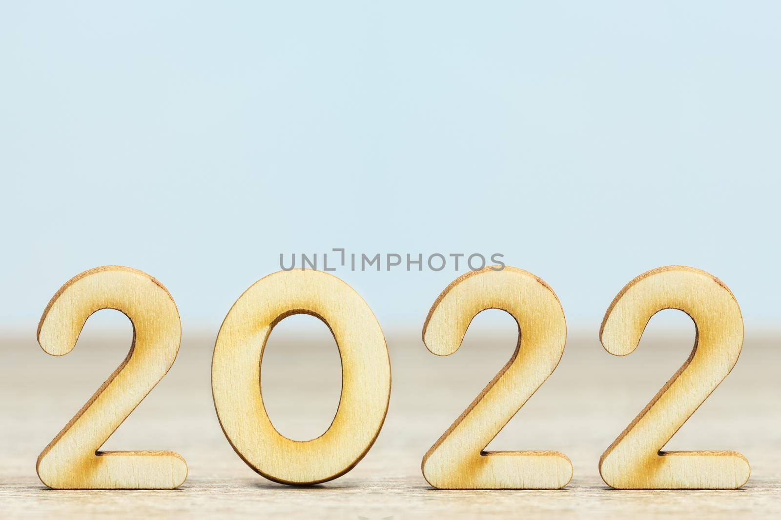 Close up wooden numeric new year 2022 on table with copy space