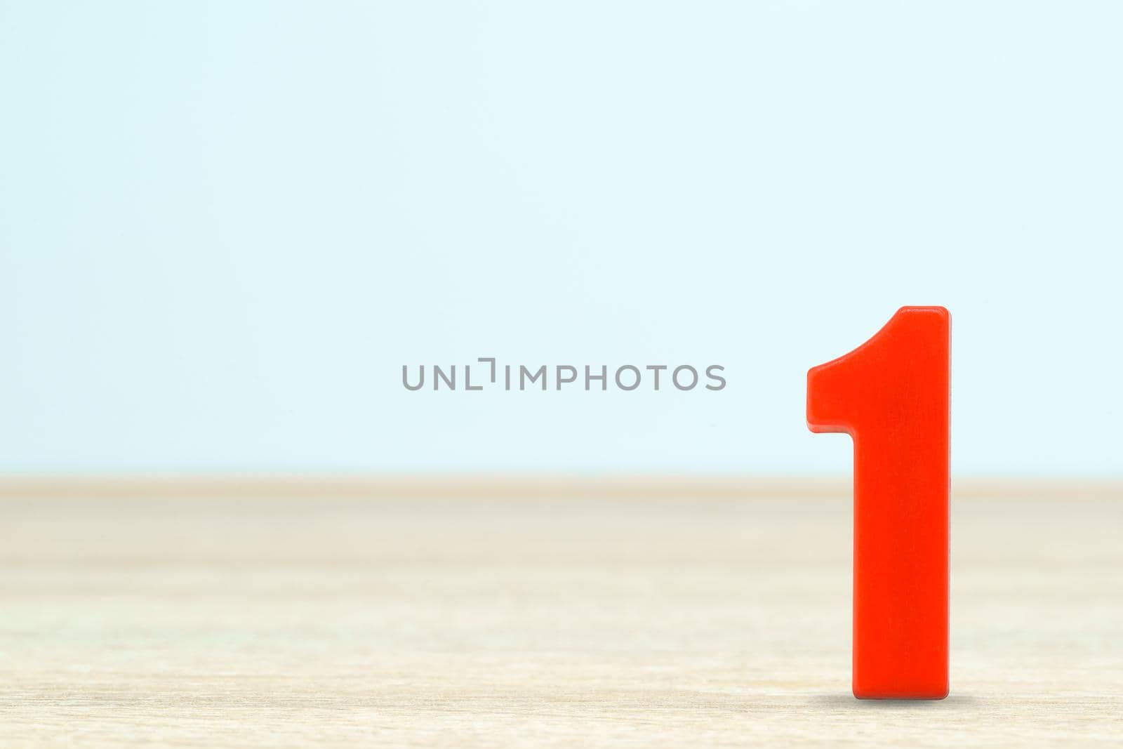 Shot of a number one made of red plastic on table with copy space