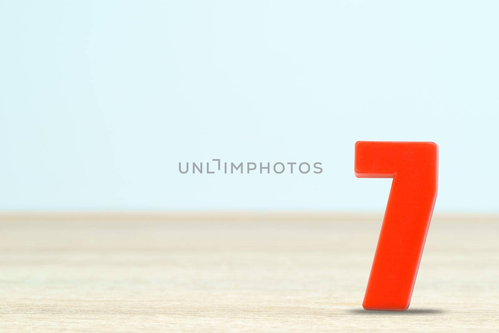 Shot of a number seven made of red plastic on table with copy space