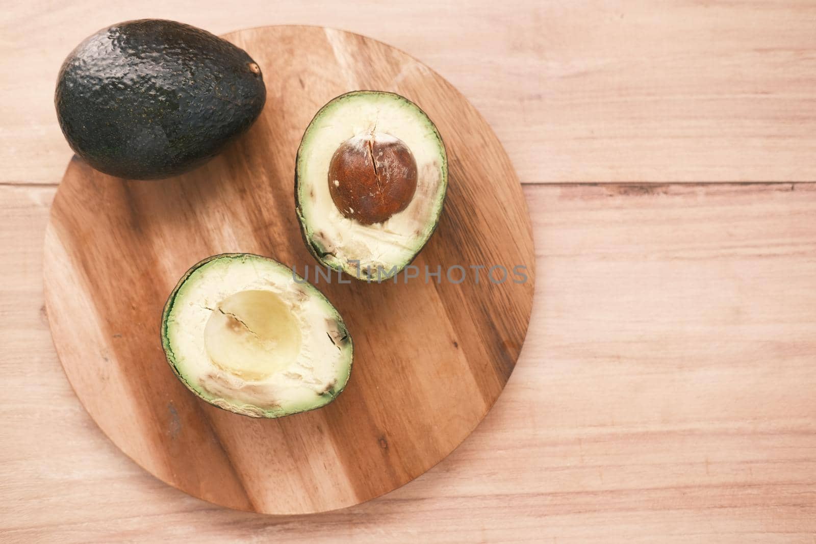 top view of slice of avocado on wooden table by towfiq007