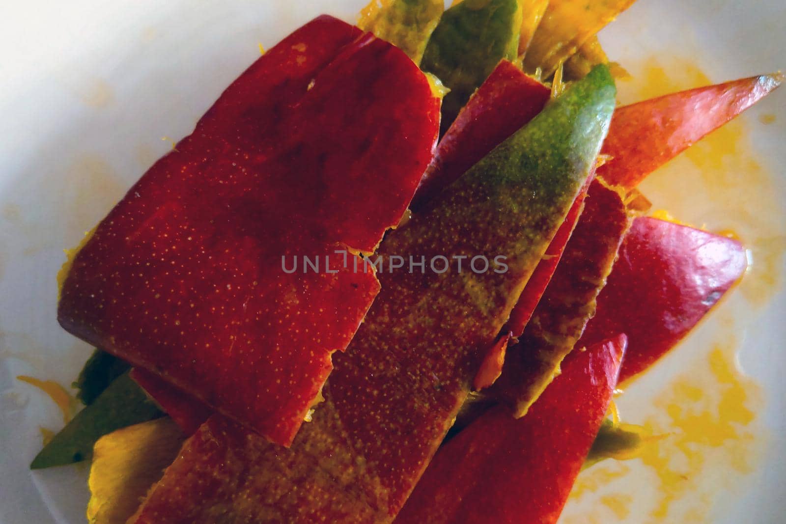 Ripe mango skins on a plate after eating. by kip02kas