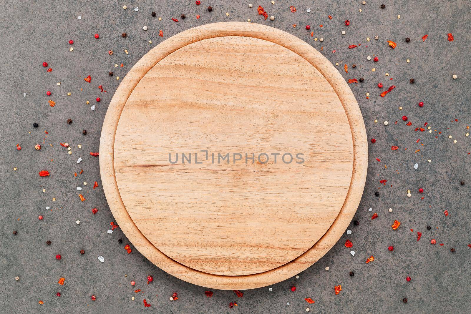 Empty pizza platte with spices set up on dark concrete background flat lay and copy space. by kerdkanno