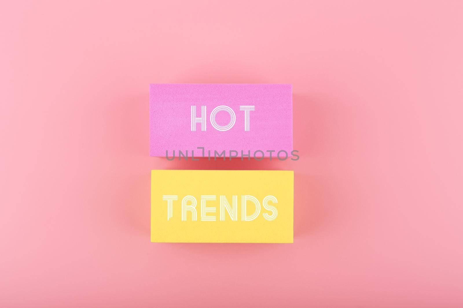 Hot trends written on colorful rectangles on light pink background. Concept of newest, latest, hot and popular trends of 2022