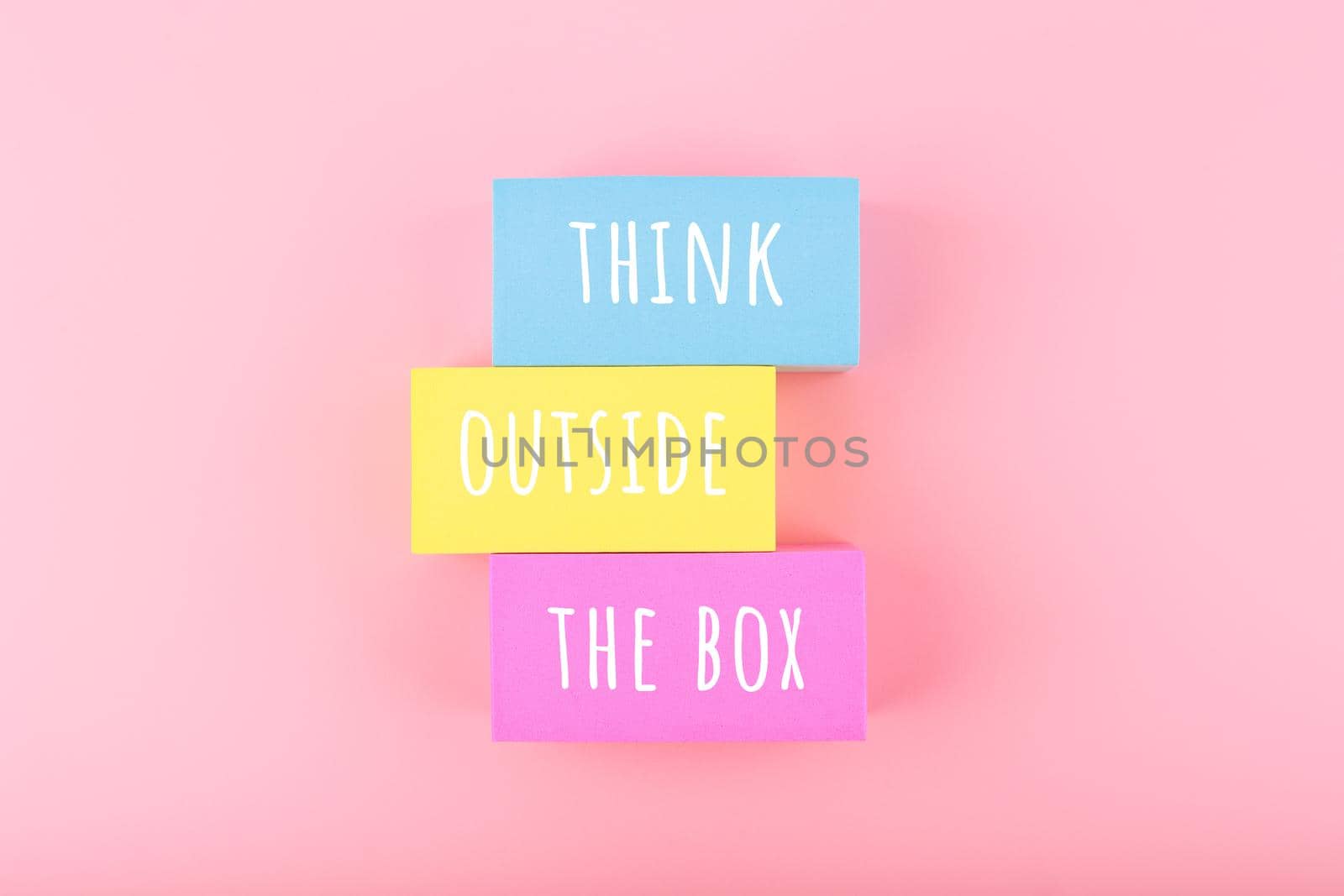 Concept of idea, creativity, start up or brainstorming. Creativity concept. Think outside the box written on colorful rectangles on bright pink background