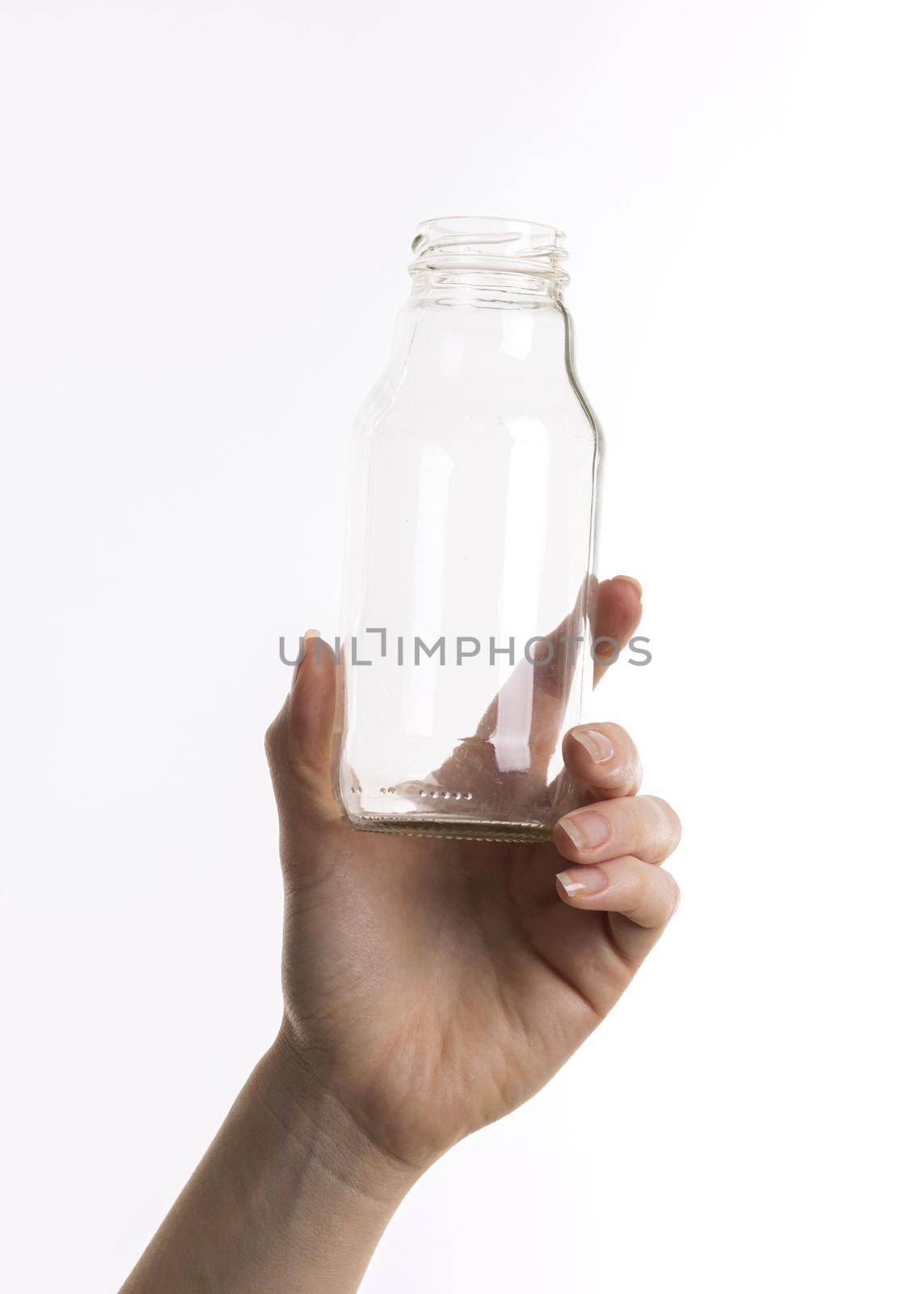 hand holding glass bottle. High quality beautiful photo concept by Zahard