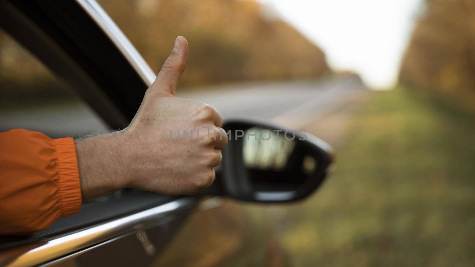 man giving thumbs up out his car while road trip. High quality beautiful photo concept by Zahard