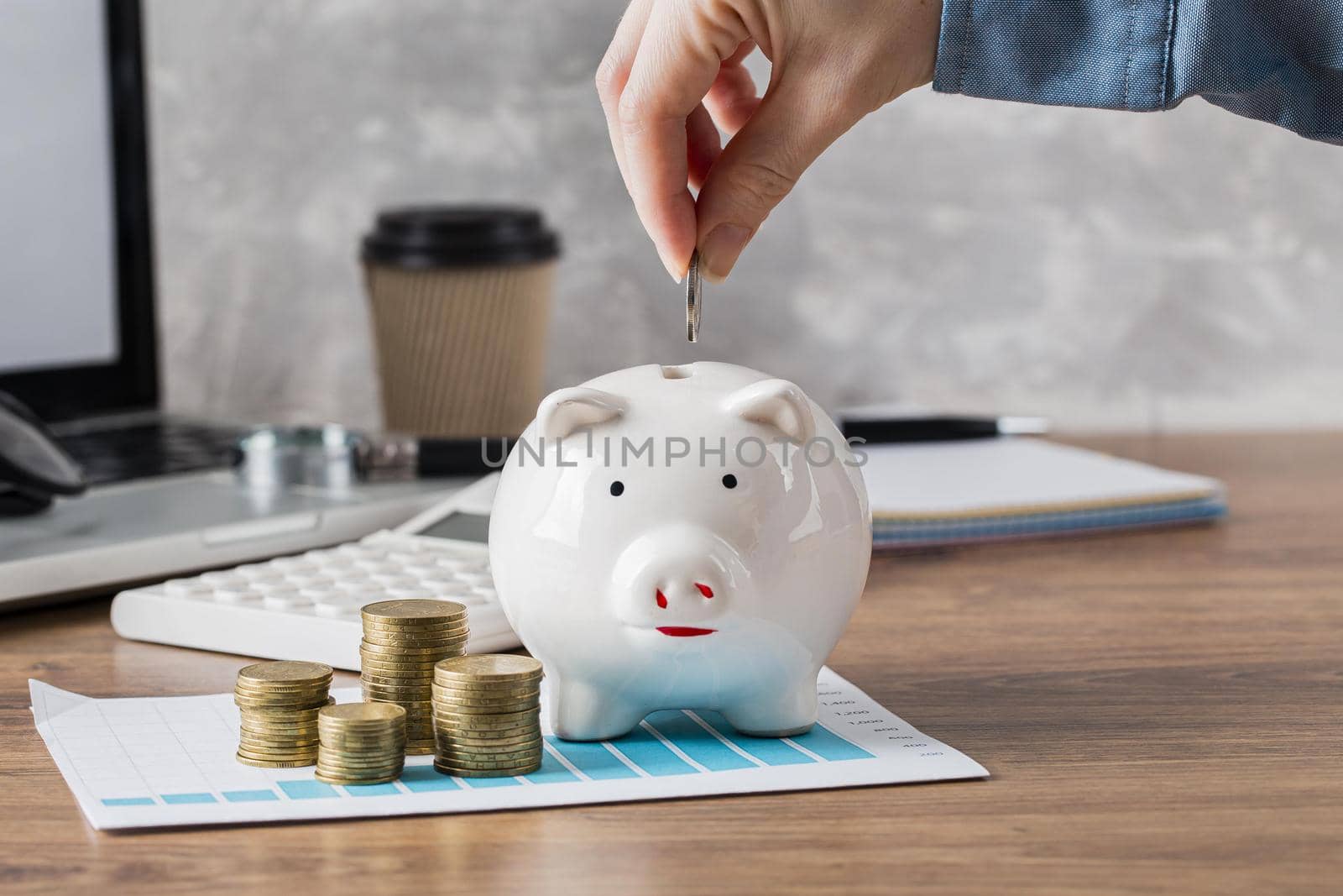 hand putting coin piggy bank growth chart. High quality beautiful photo concept by Zahard
