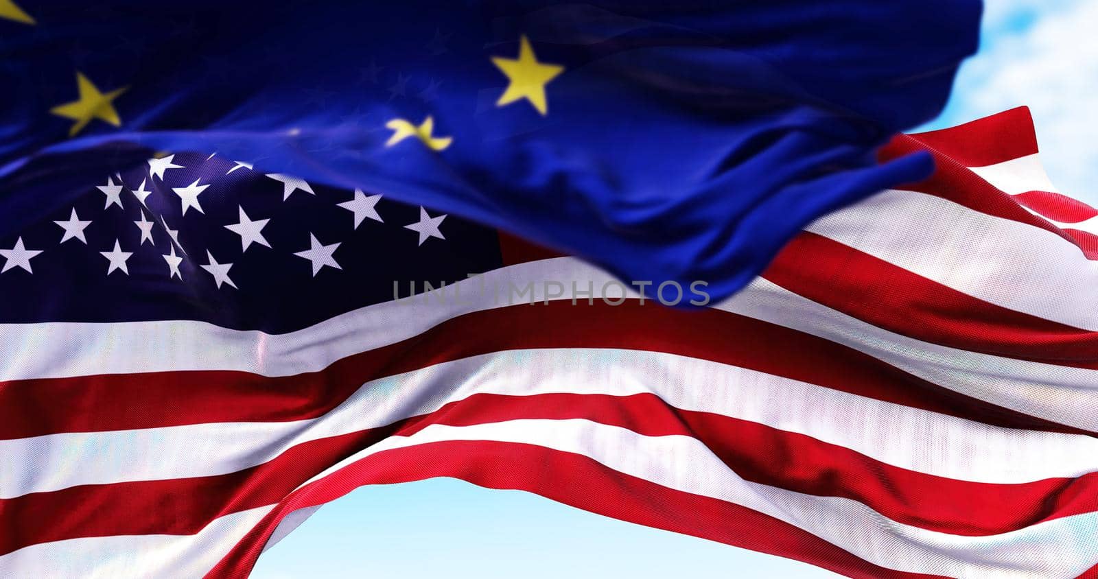 The national flag of the United states of America waving in the wind with the European Union flag by rarrarorro