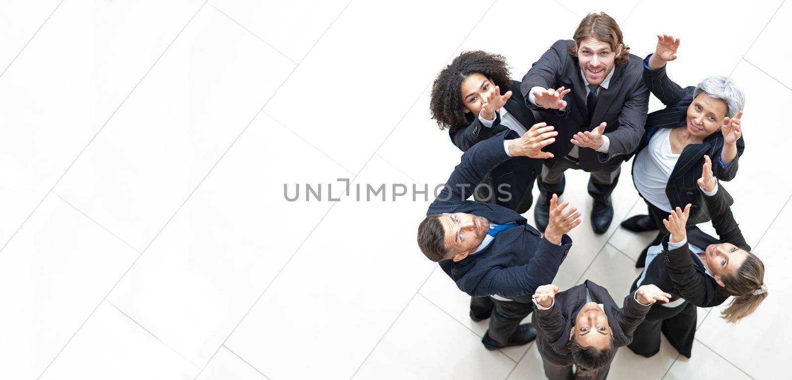 Top view of business people with their hands together in a circle with high-five
