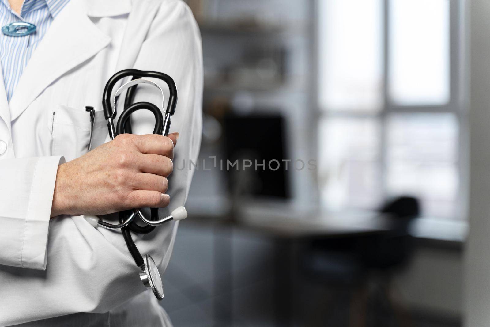 front view female doctor holding stethoscope with copy space. High quality beautiful photo concept by Zahard