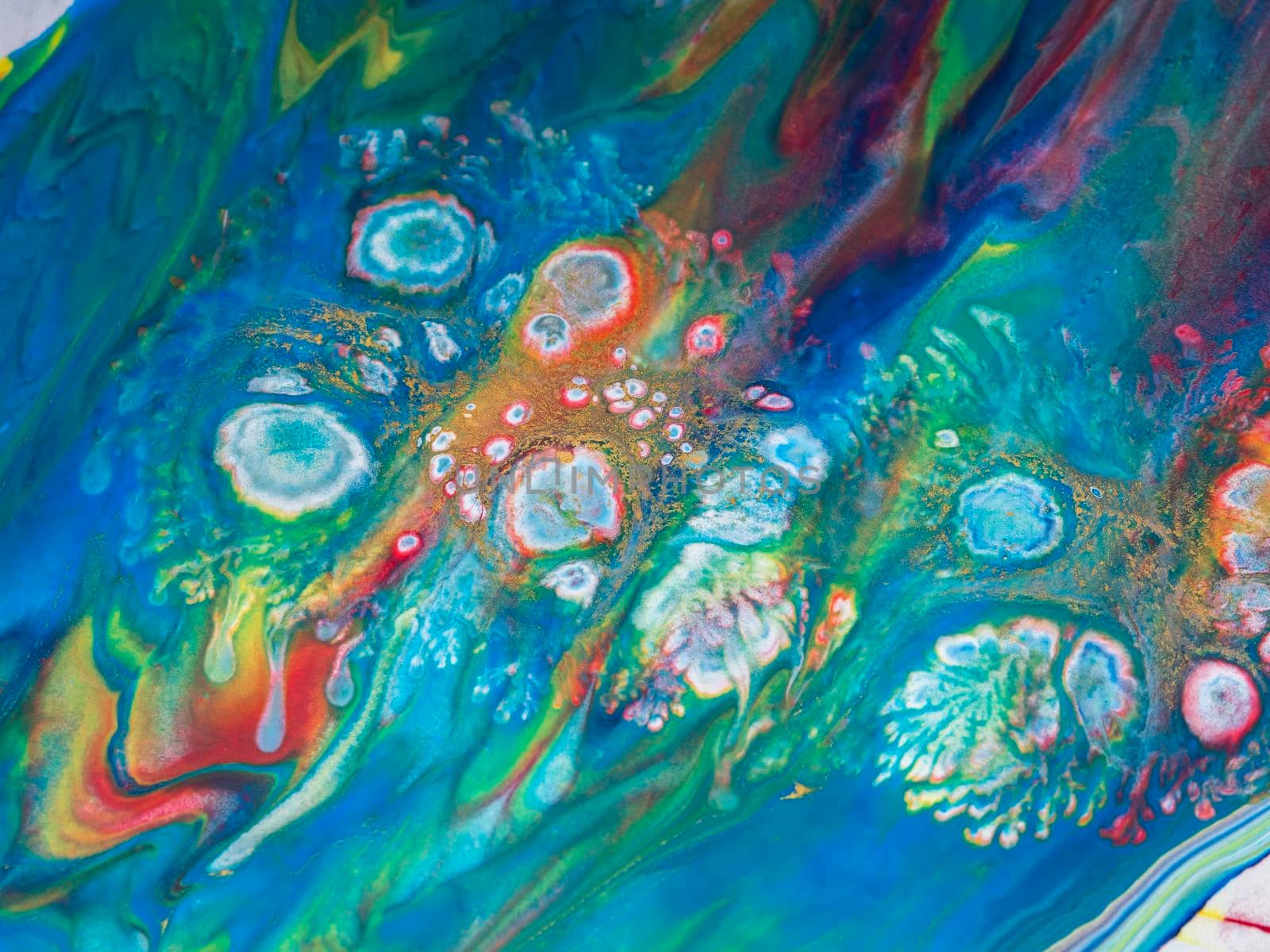 Abstract colorful background of spreading flowers. A unique screensaver picture. Background image. Acrylic paints. Alcohol ink. Drops on a blue-red background.