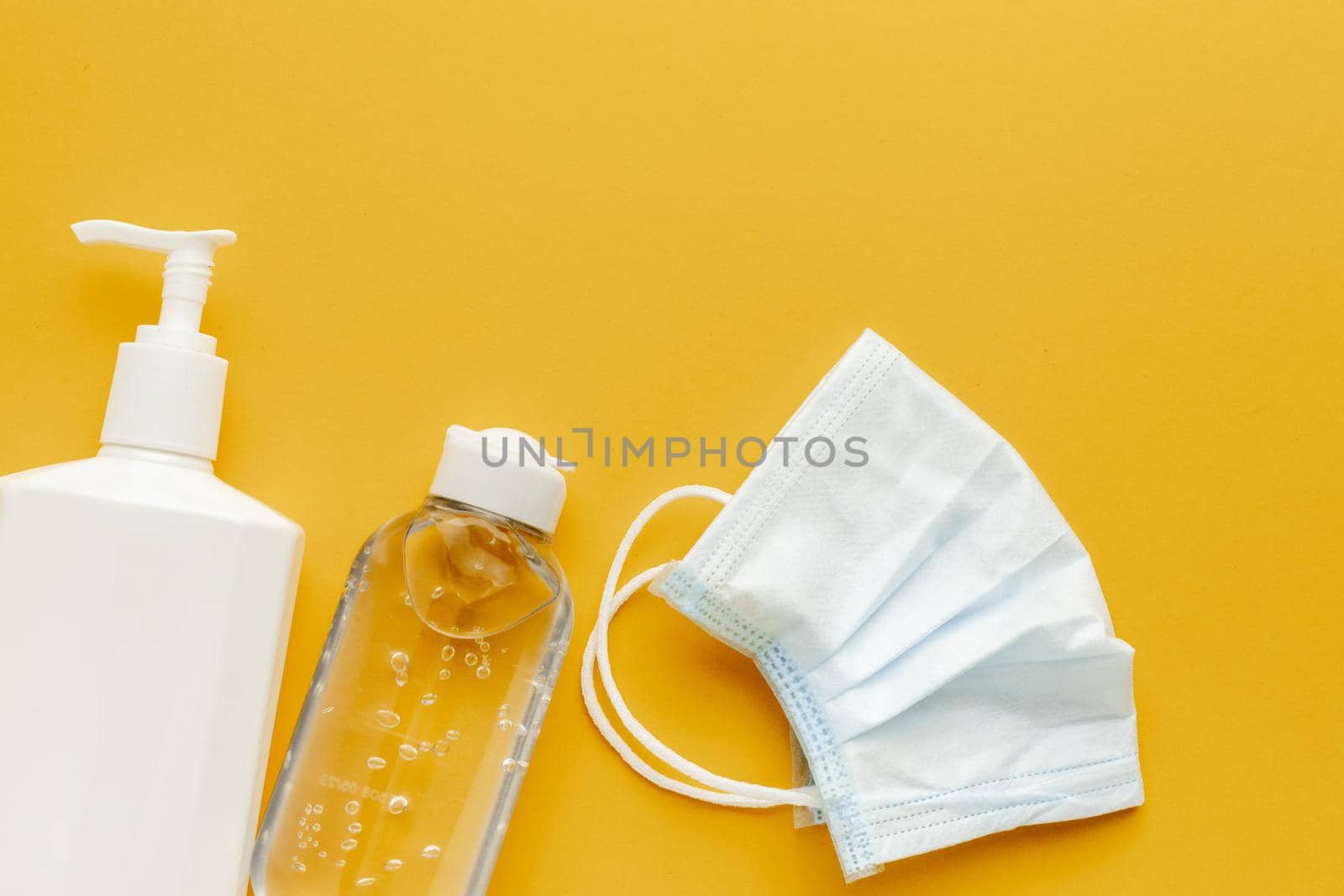 flat lay medical mask with liquid bottle hand sanitizer. High quality beautiful photo concept by Zahard