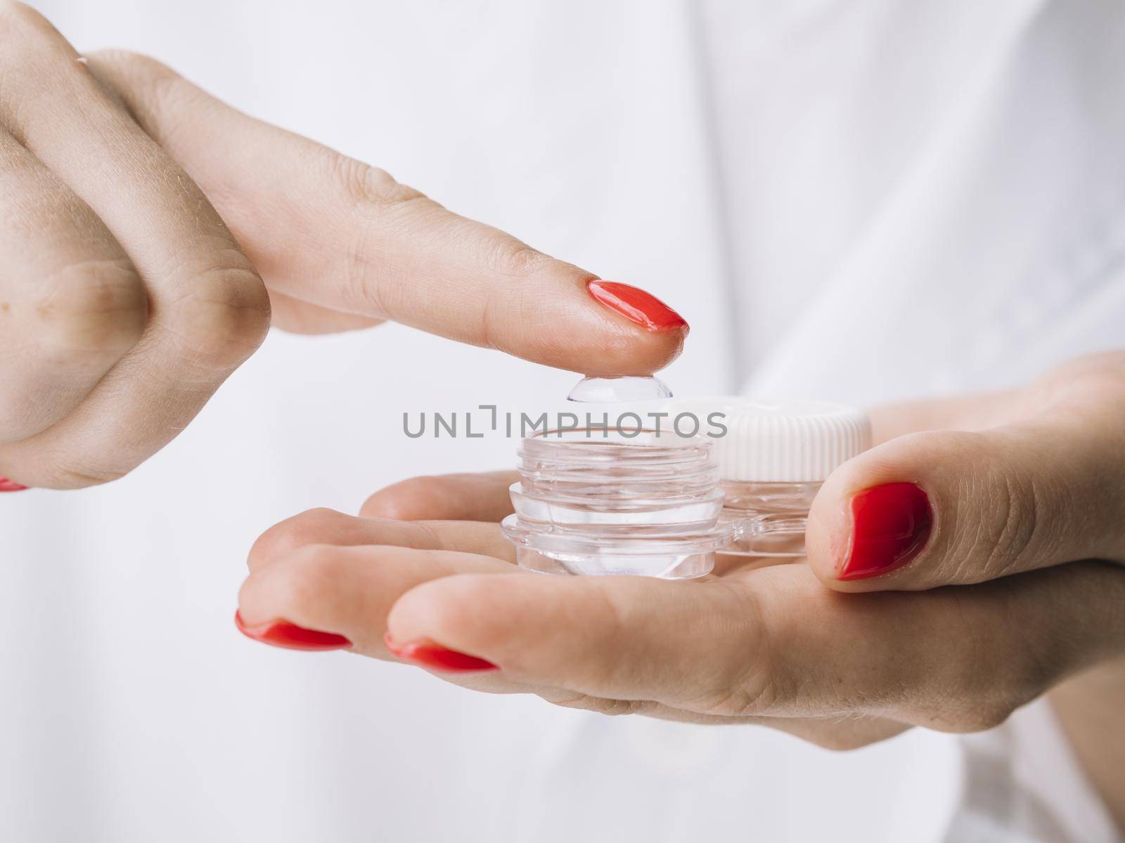 female pulling out contact lenses from box. High quality beautiful photo concept by Zahard