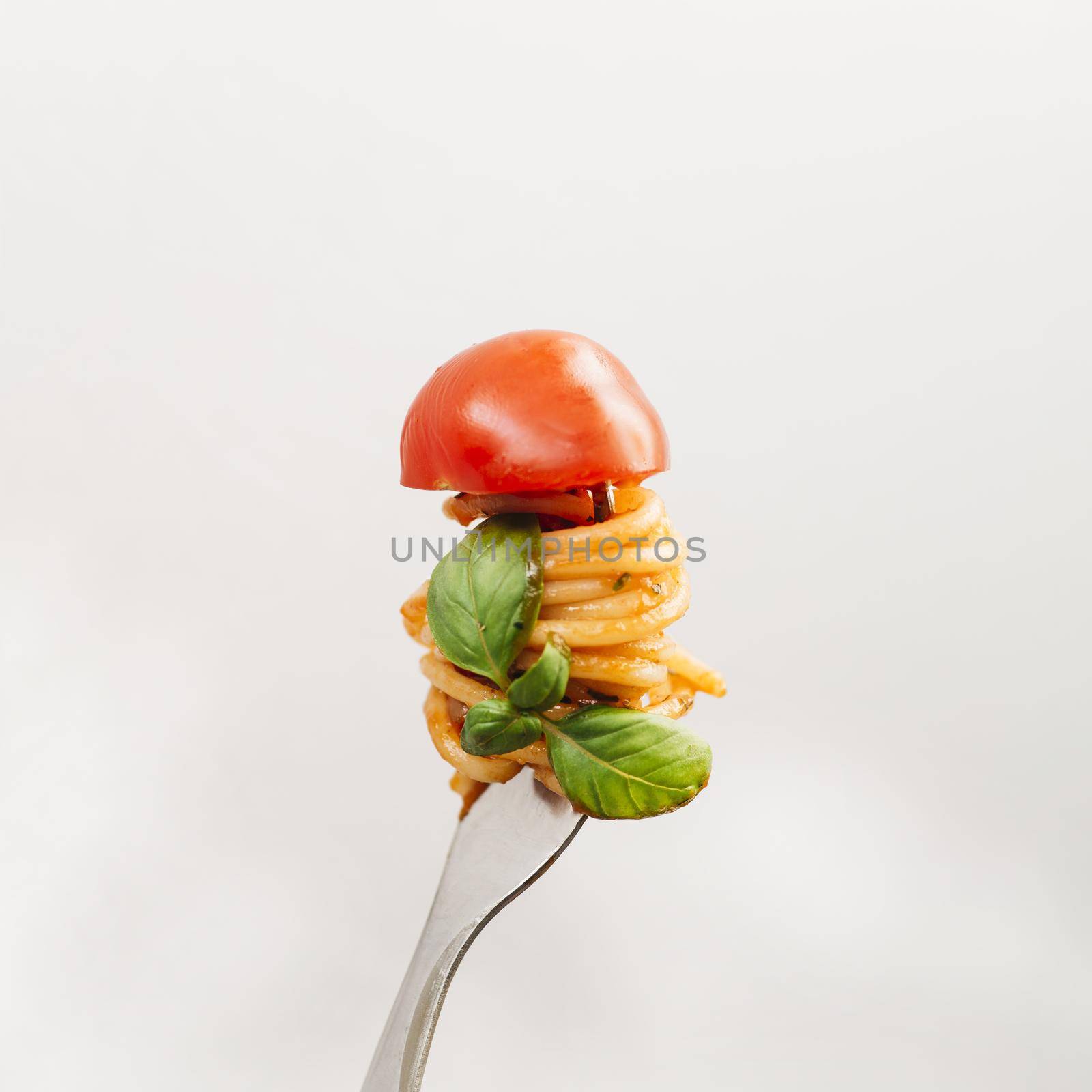 tasty spaghetti wrapped around fork. High quality beautiful photo concept by Zahard