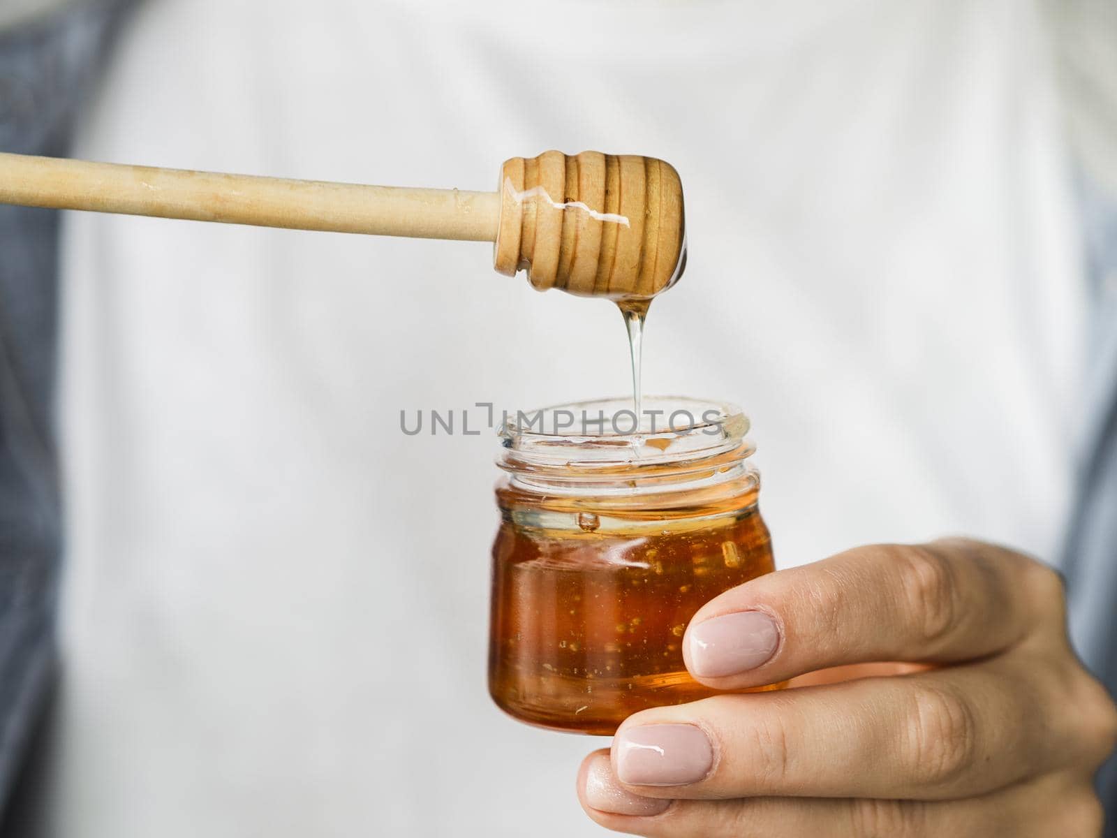 hand holding sweet honey jar. High quality beautiful photo concept by Zahard