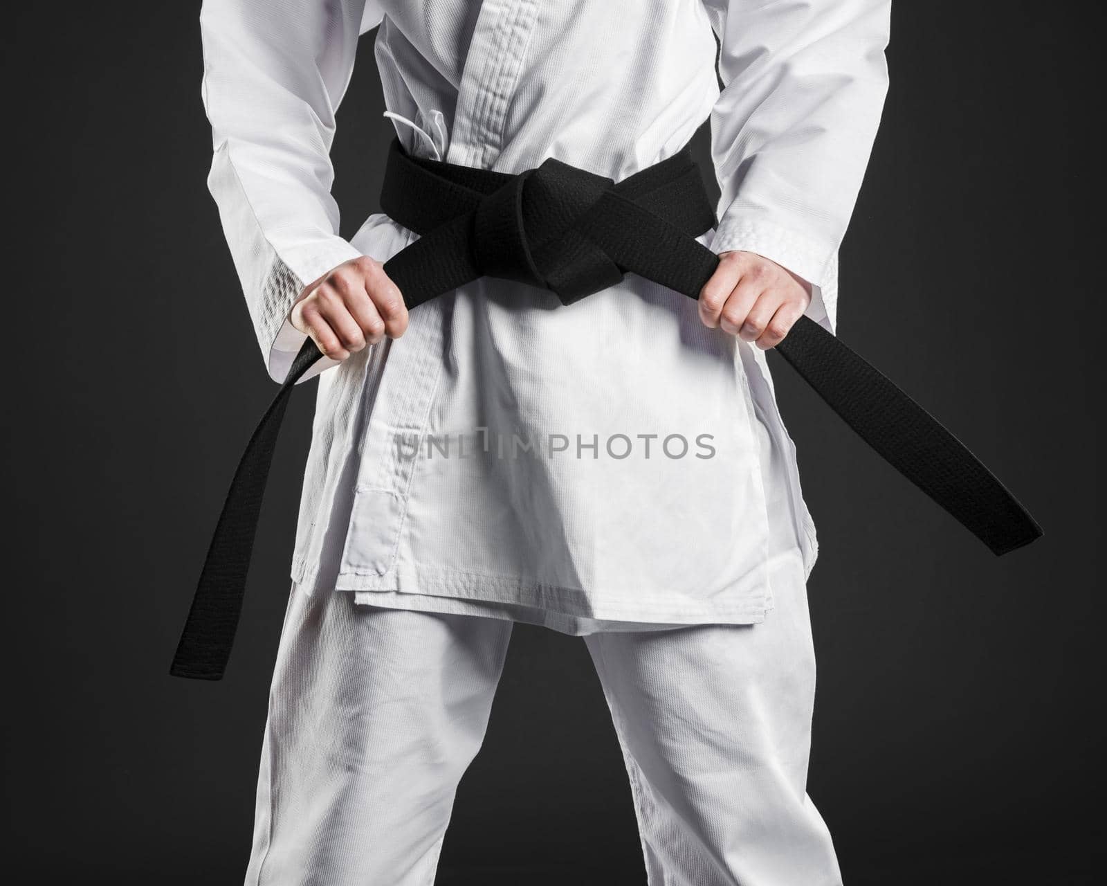 karate fighter proudly holding black belt. High quality beautiful photo concept by Zahard