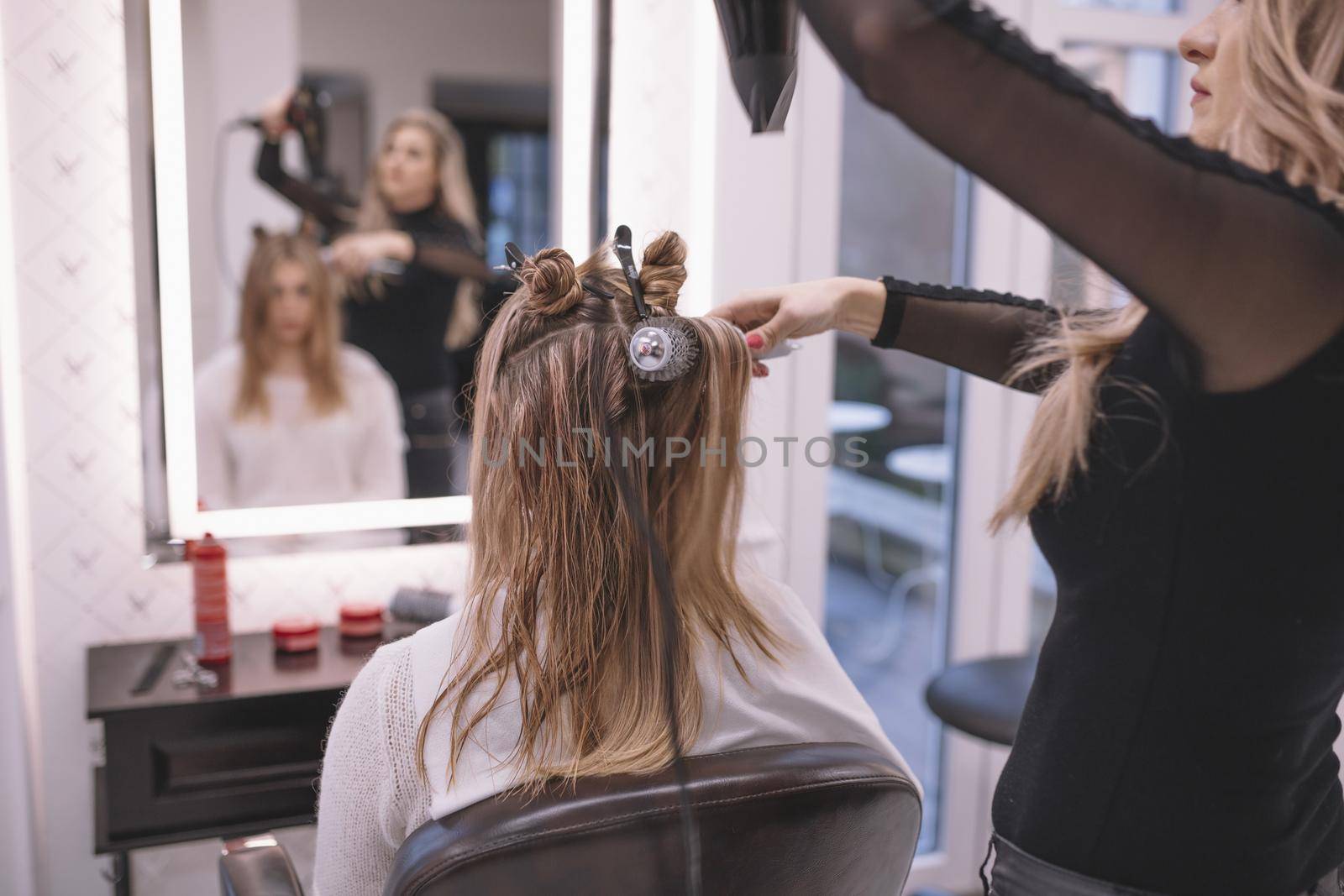 professional hairstylist setting hair client. High quality beautiful photo concept by Zahard