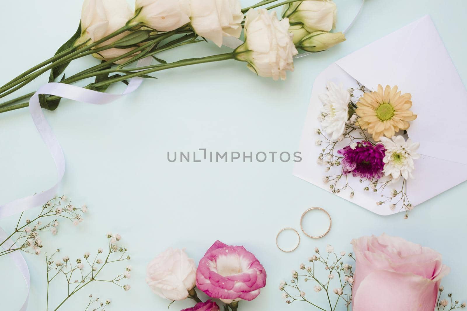 wedding rings flower decoration blue pastel background. High quality beautiful photo concept by Zahard