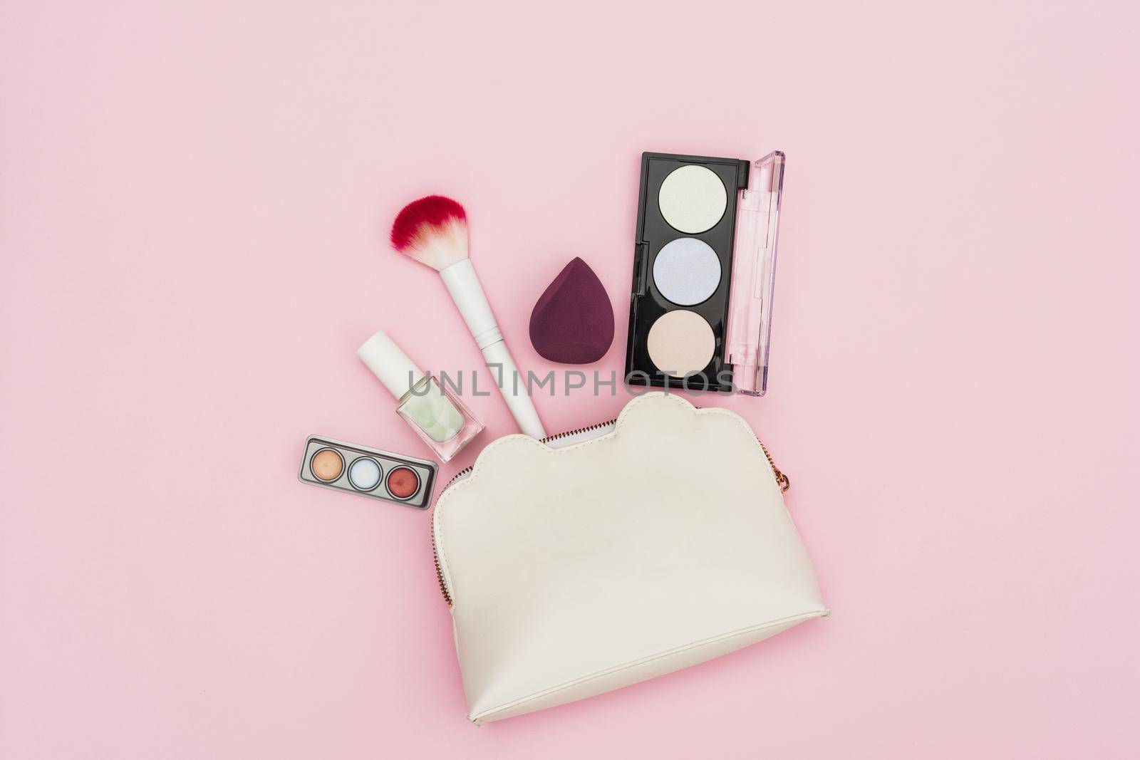 eyeshadow palette nail polish bottle blender makeup brush makeup bag pink background. High quality beautiful photo concept by Zahard