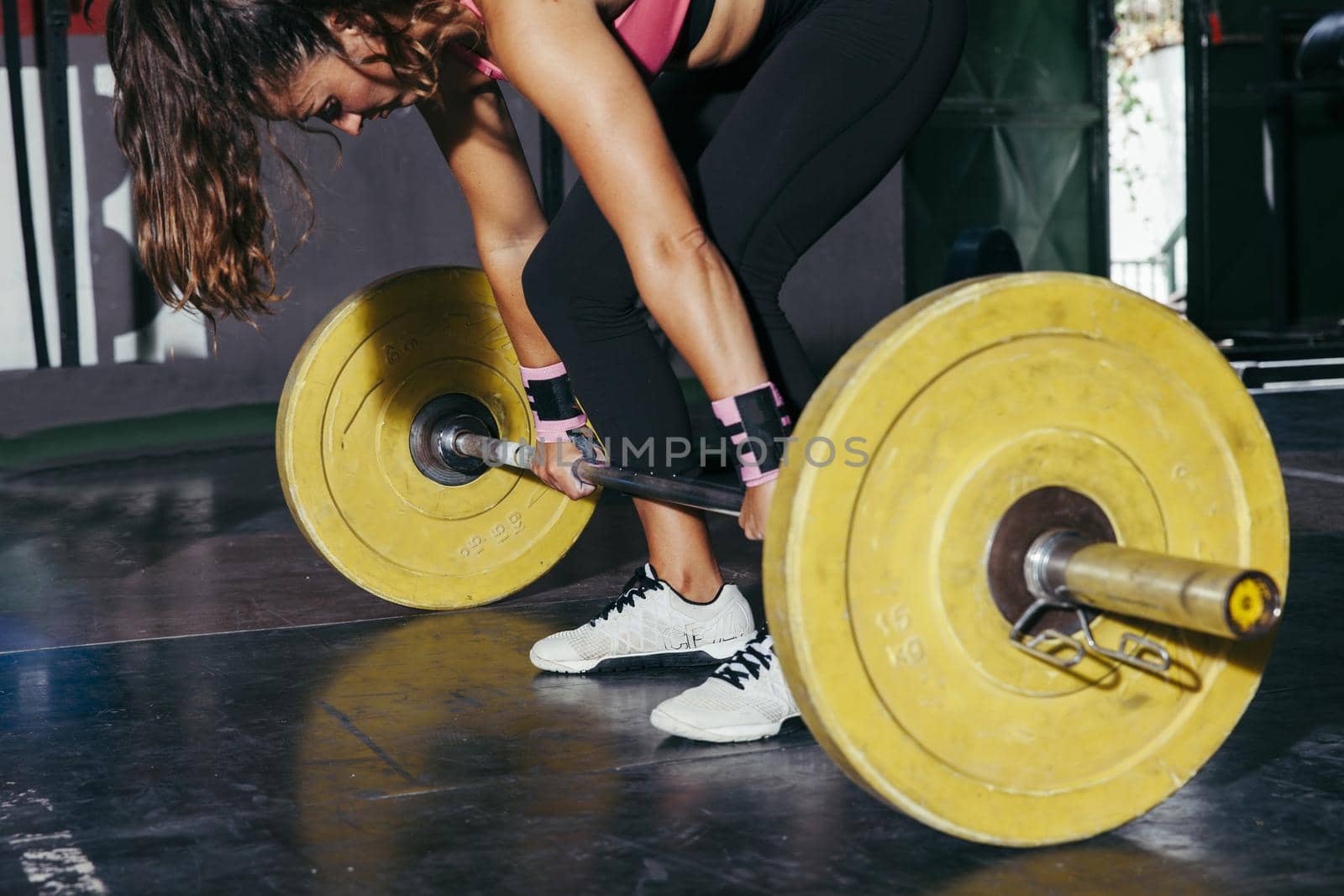 woman with yellow barbell gym. Resolution and high quality beautiful photo