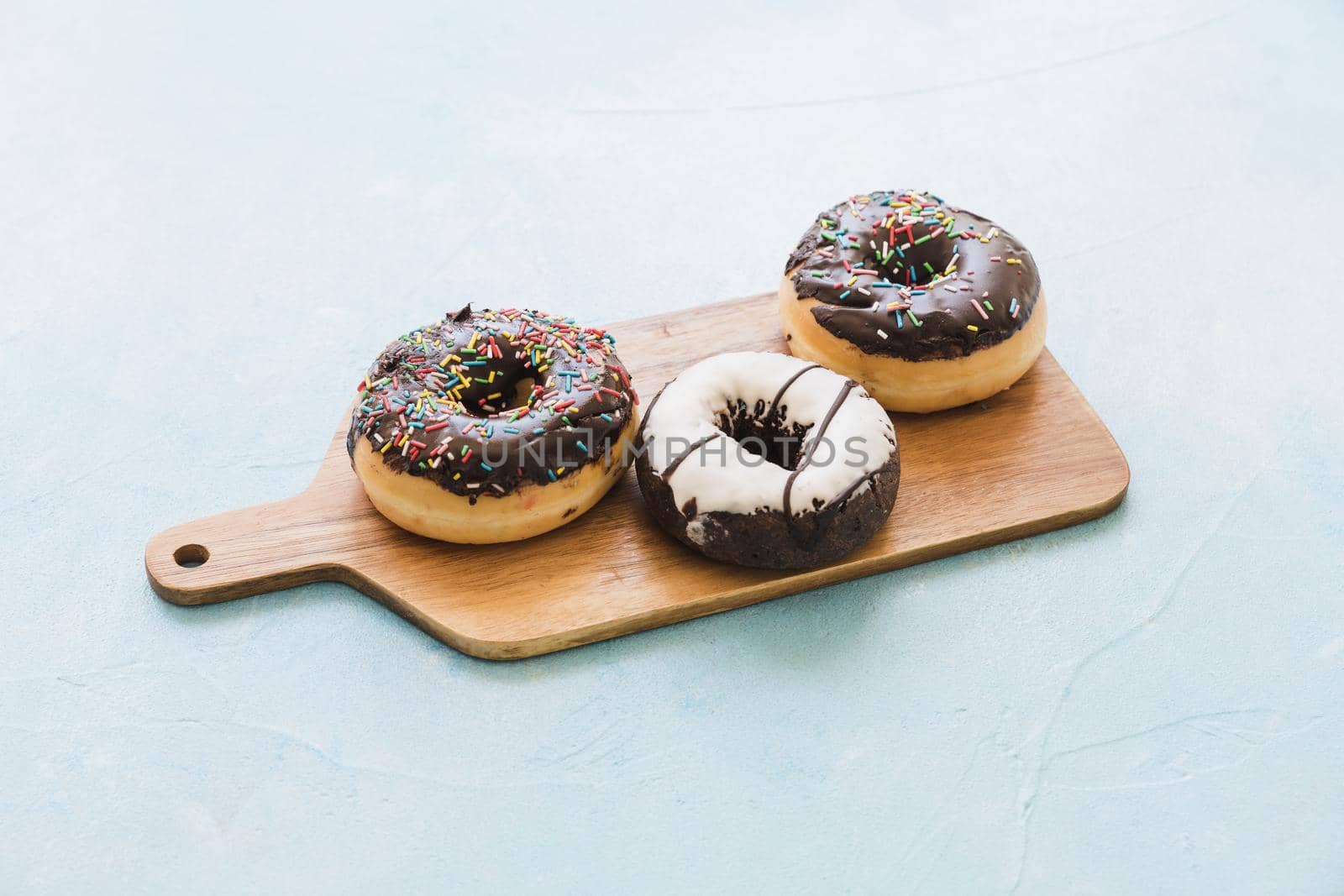 fresh chocolate donuts chopping board. Resolution and high quality beautiful photo