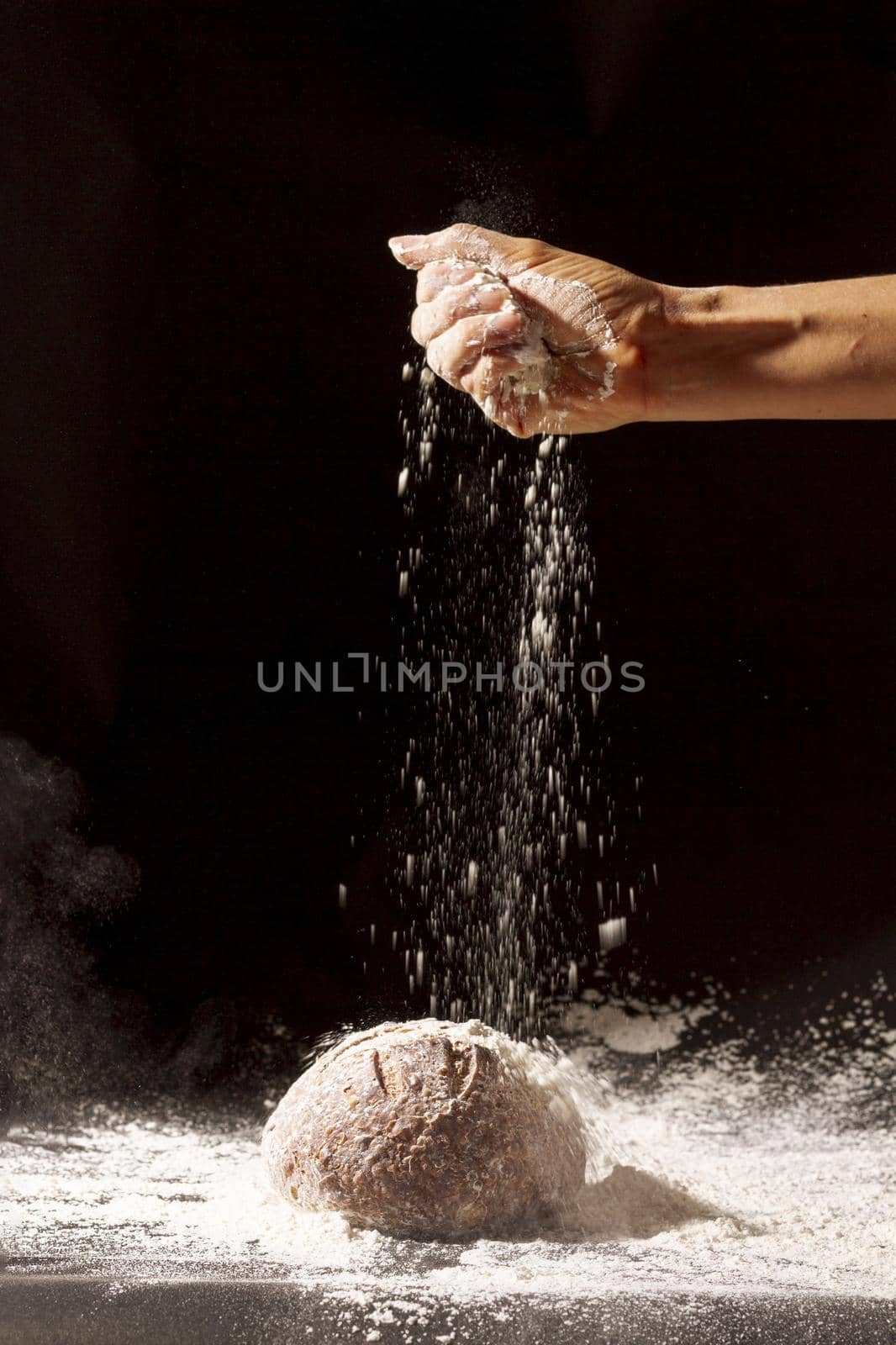 hand pours flour baked bread. High quality beautiful photo concept by Zahard