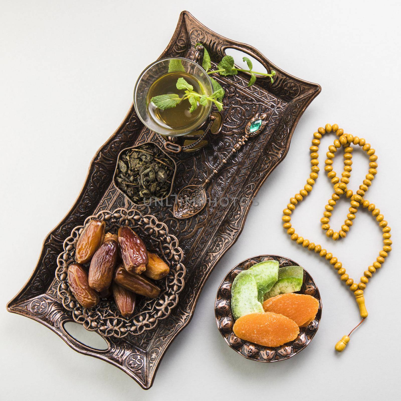 tea glass with dates fruit beads tray. High quality beautiful photo concept by Zahard