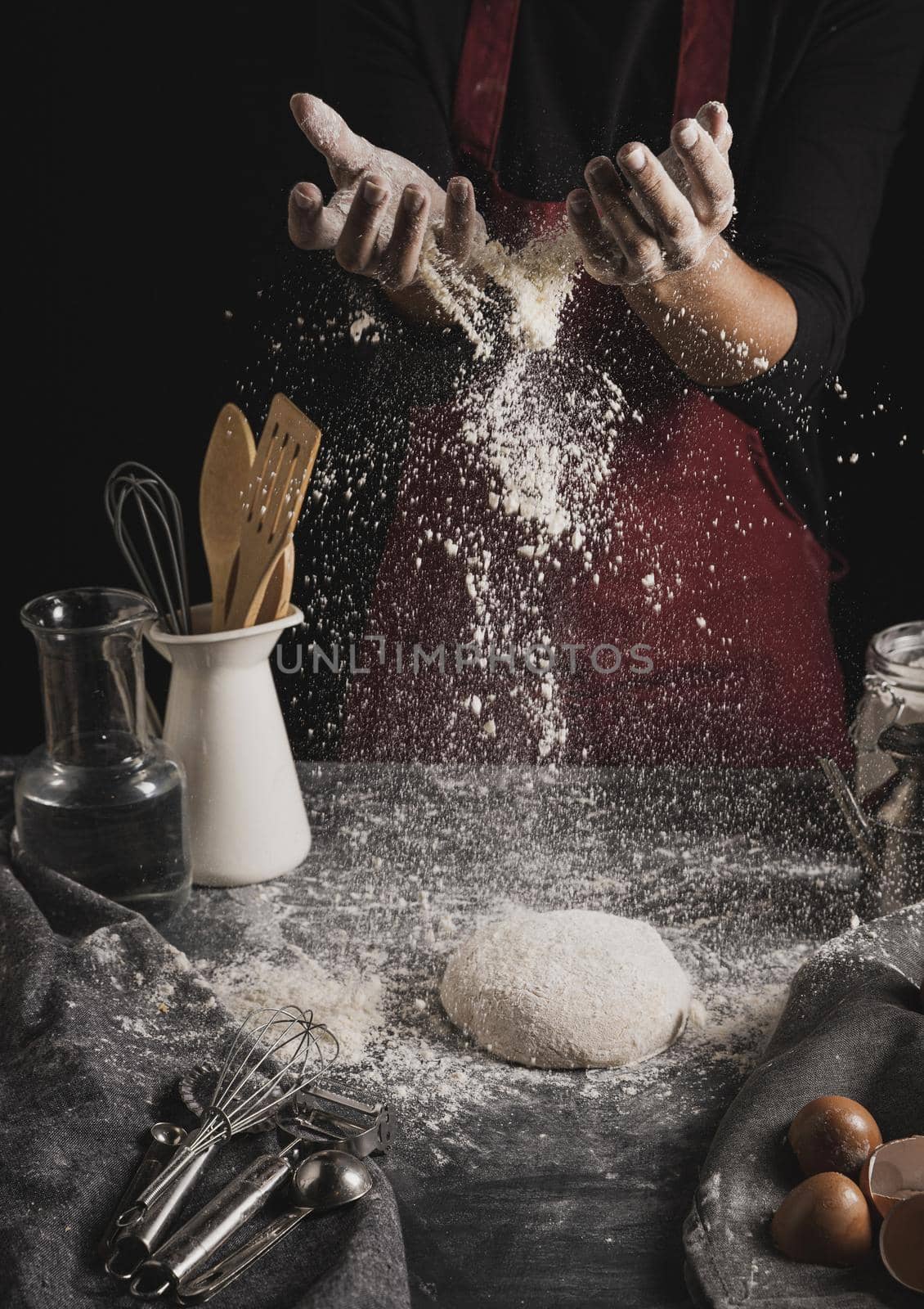 front view baker hands spreading flour. High quality beautiful photo concept by Zahard