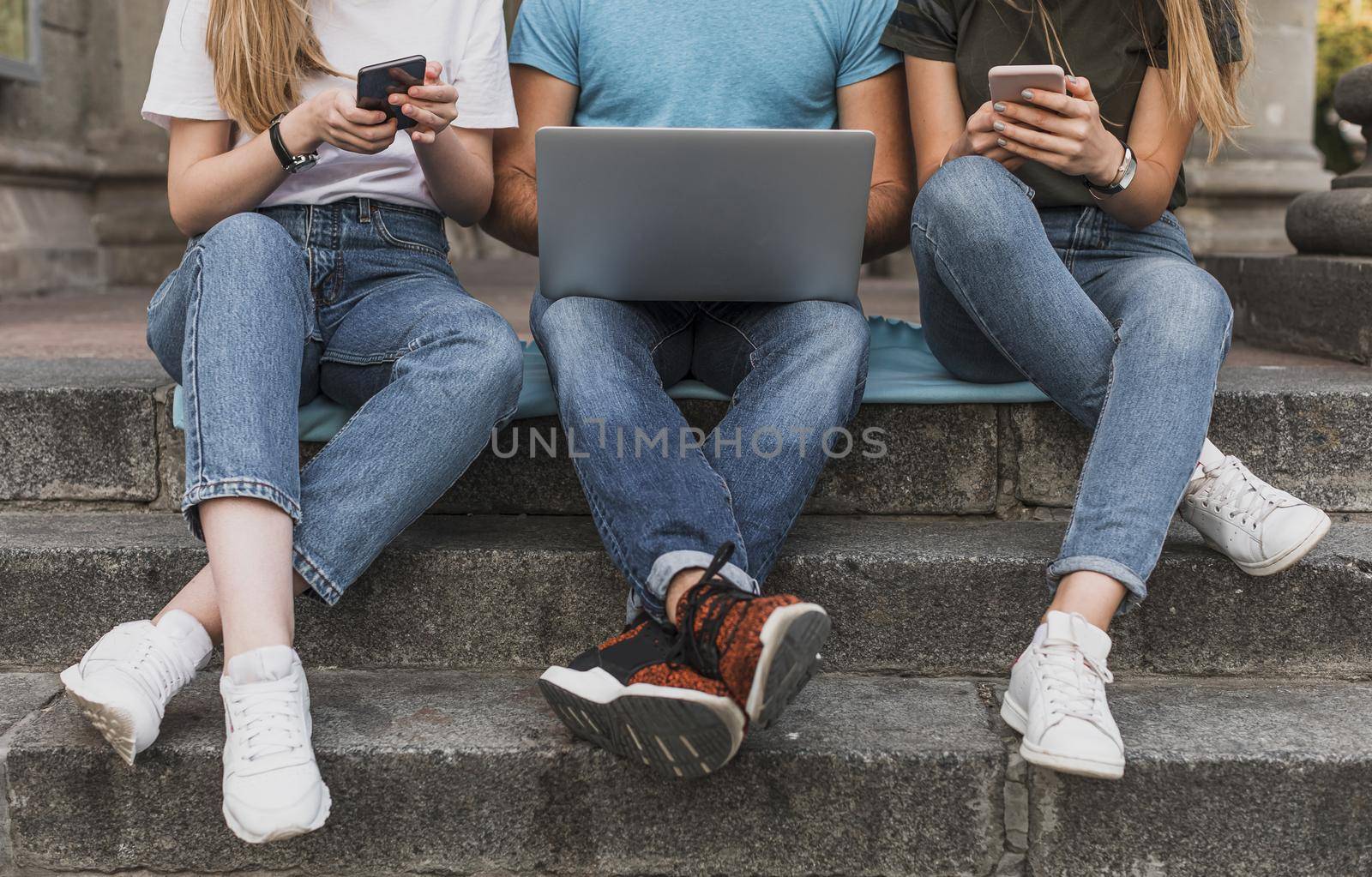 teens sitting stairs working phones laptop. High quality beautiful photo concept by Zahard