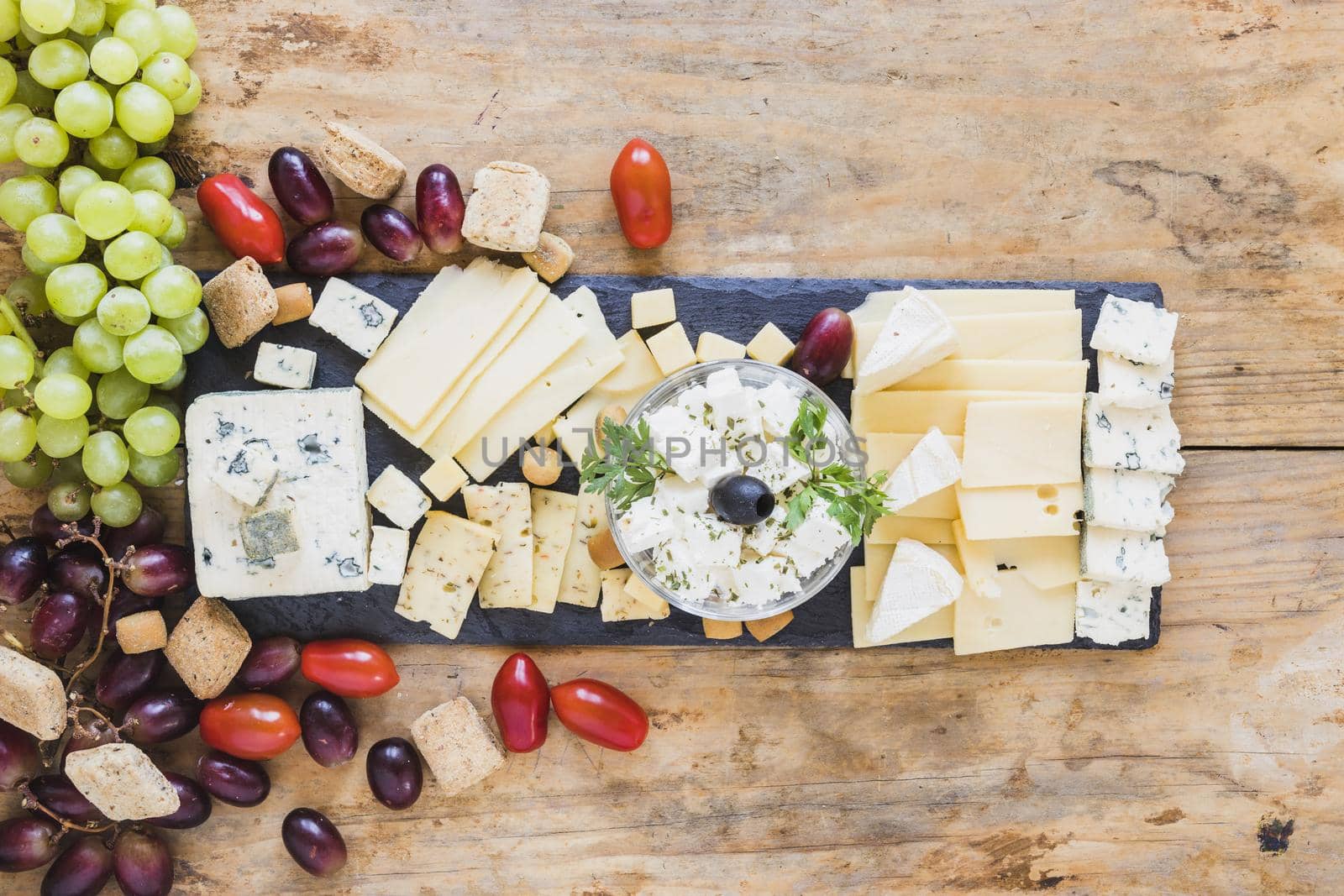 tasty appetizers with cheese plate tomatoes grapes. High quality beautiful photo concept by Zahard