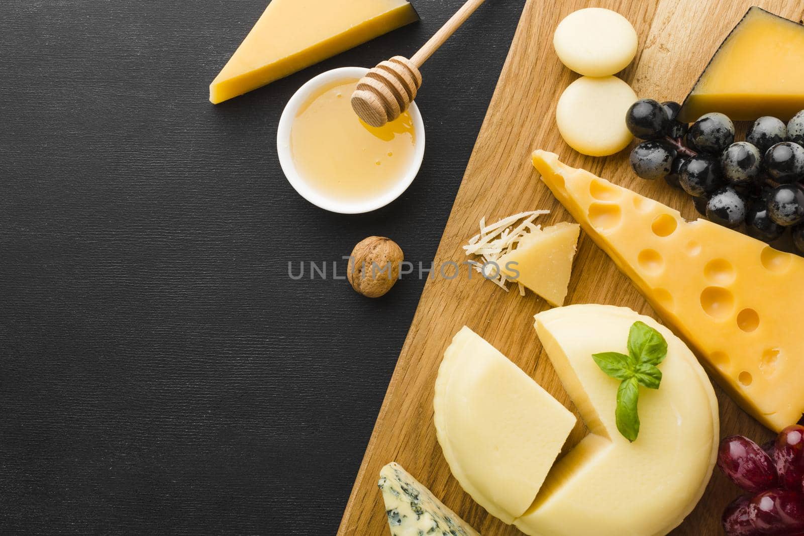 flat lay mix gourmet cheese grapes cutting board with honey. High quality beautiful photo concept by Zahard