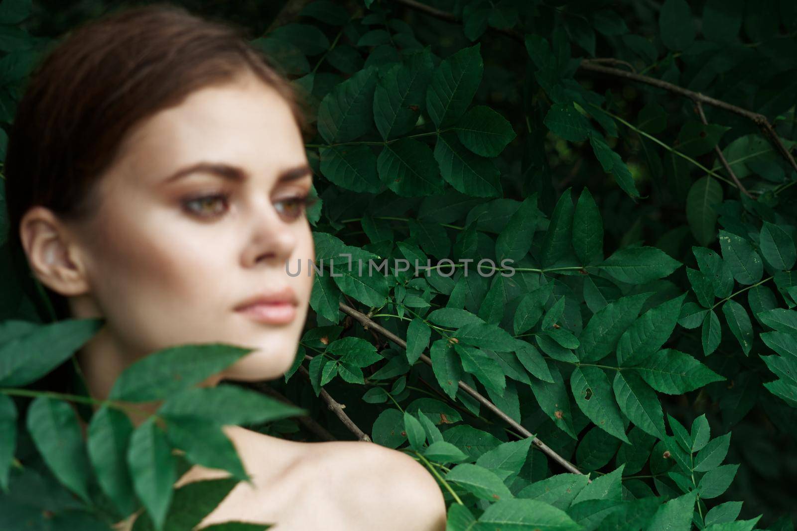 attractive woman skin care bare shoulders green leaves nature close-up by Vichizh